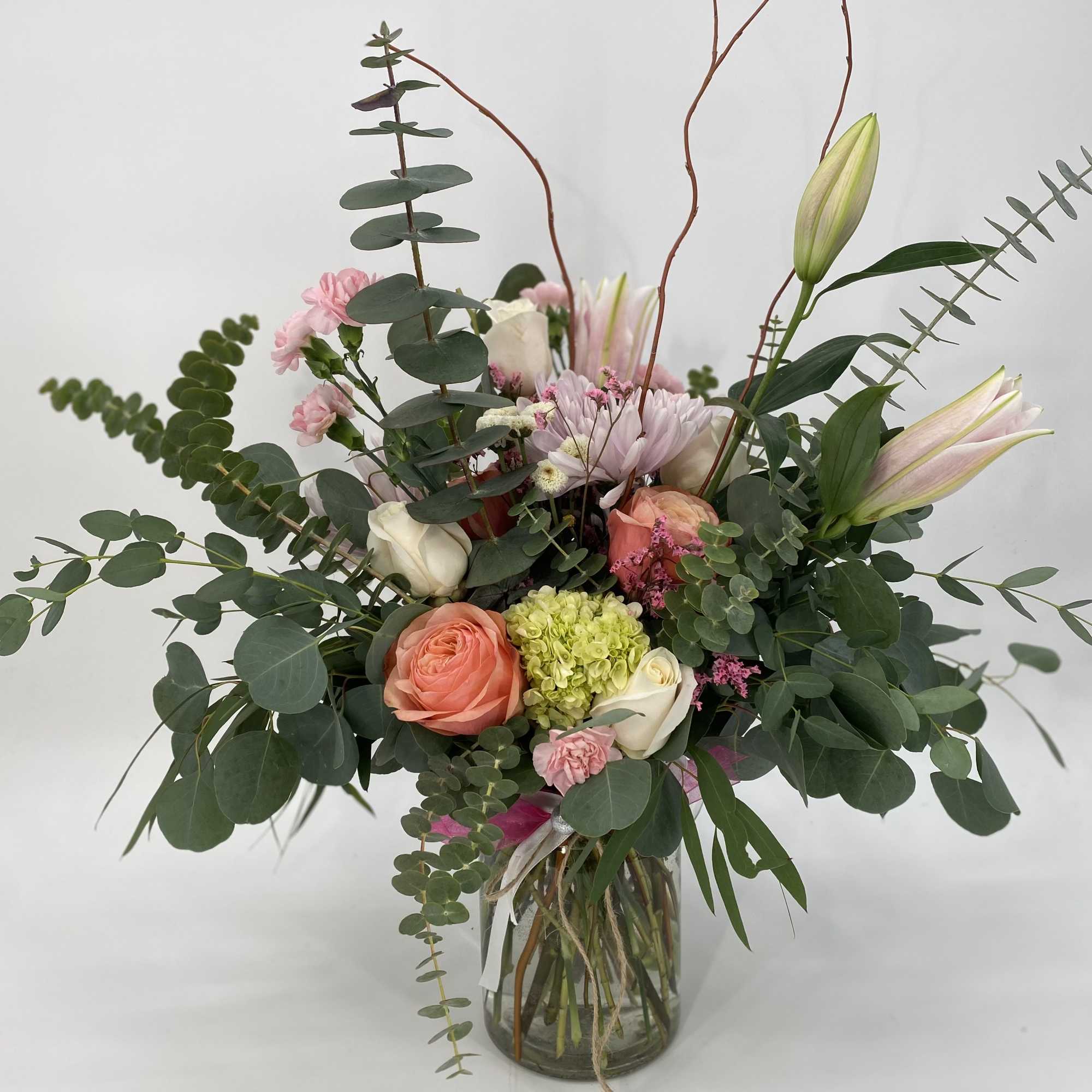 Mixed bouquet of pink and white flowers in a glass vase