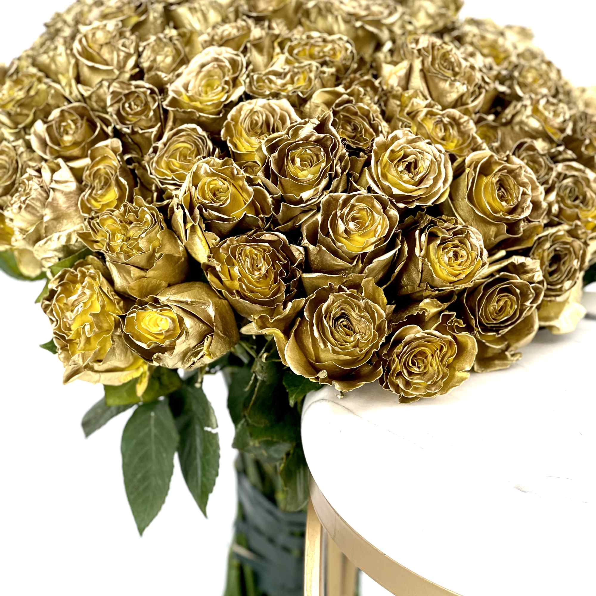 Bouquet of gold-toned roses with a glass vase