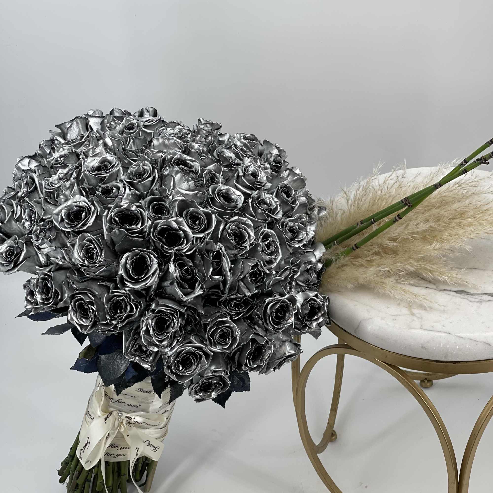 Large bouquet of metallic silver roses with a ribbon wrap