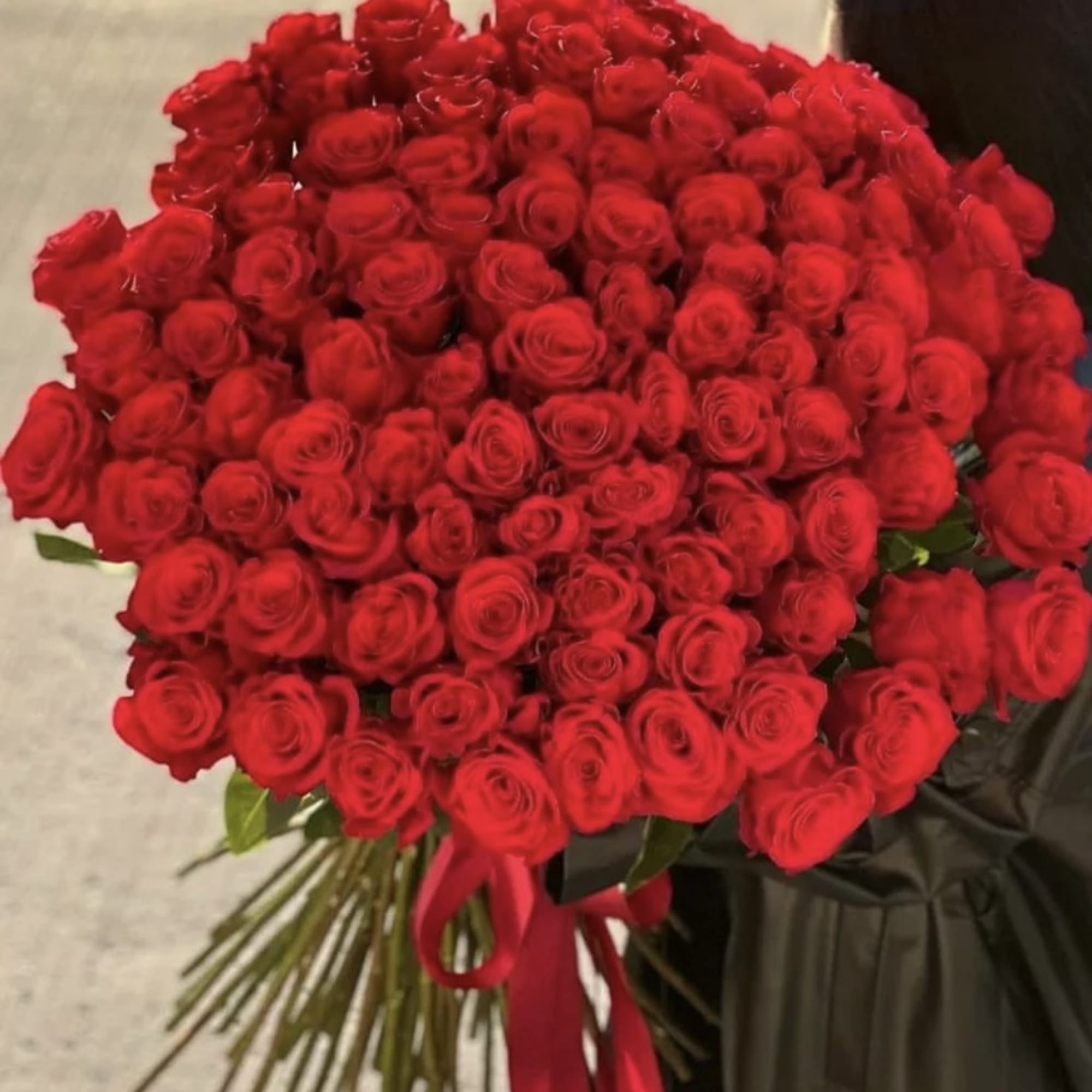 Large bouquet of red roses tied with a red ribbon