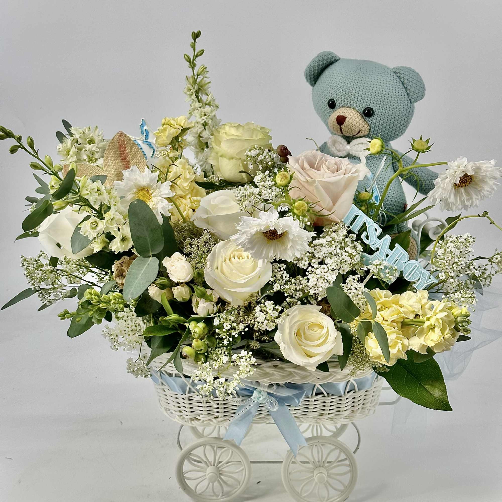 An elegant baby -boy arrangement of soft ivory and cream blooms accented