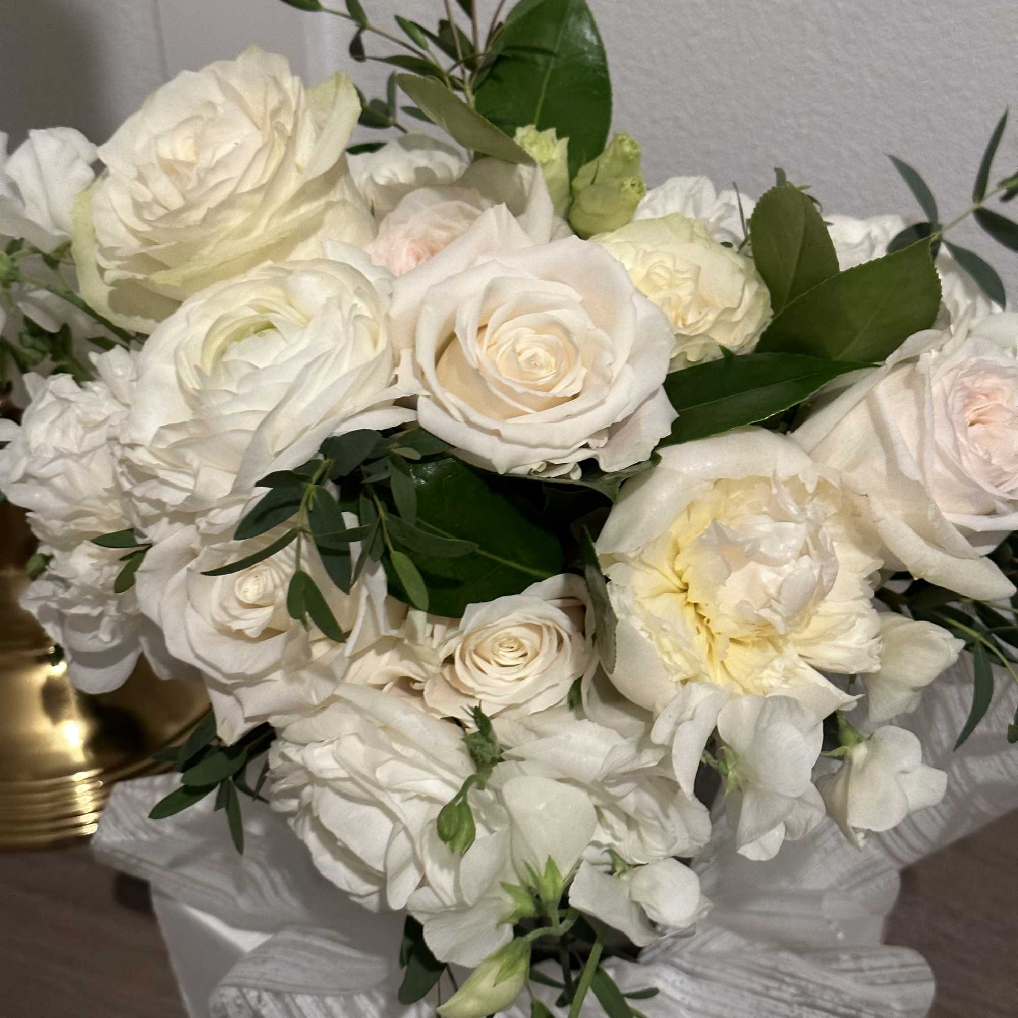 White rose bouquet with pale blooms and greenery