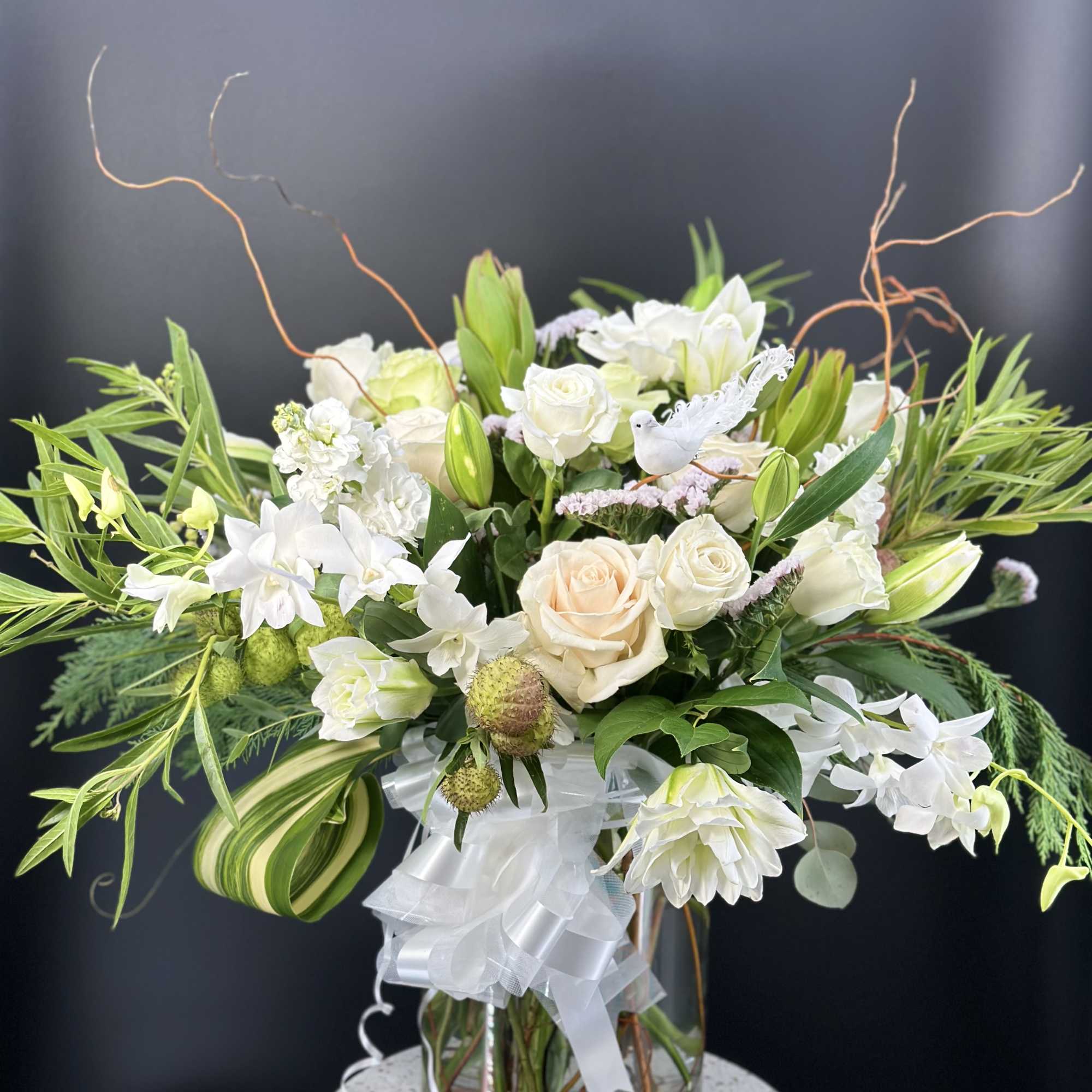 White and cream floral arrangement in a glass vase with a white ribbon, photo 4 of 9