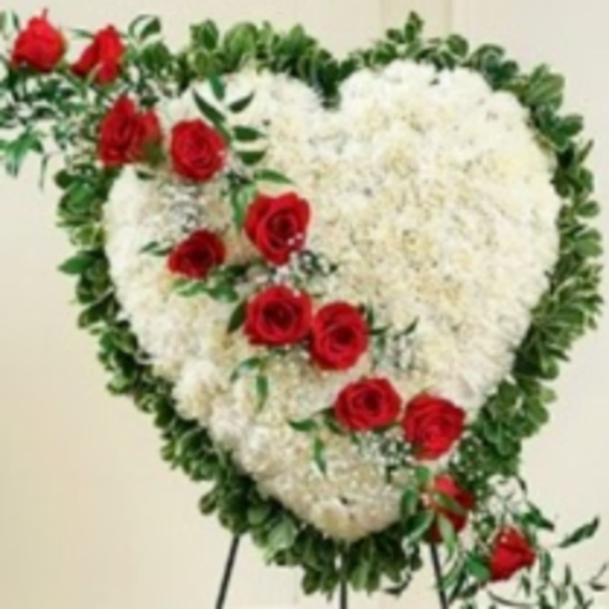 This solid white heart standing spray, accented with a slash of beautiful