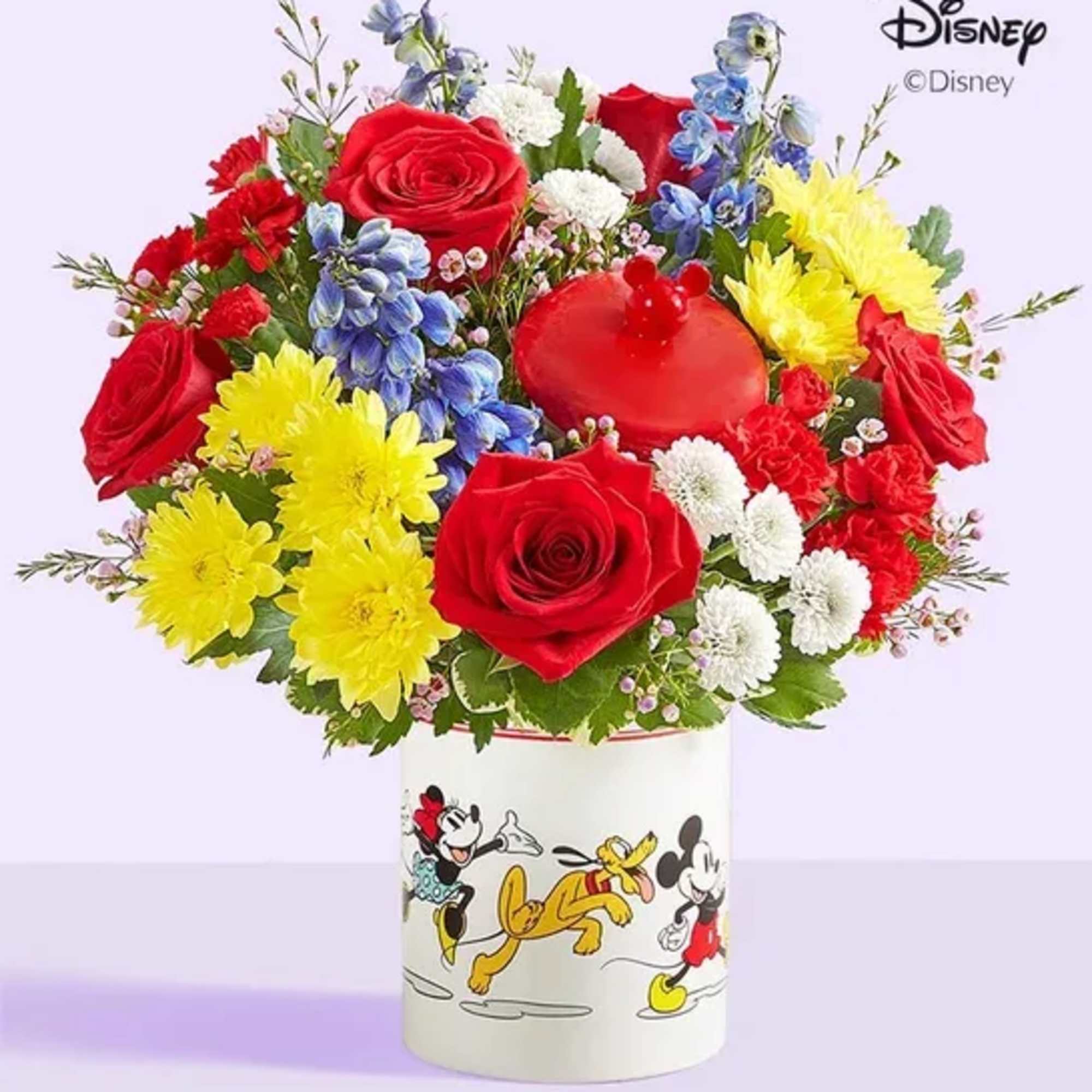 Colorful bouquet of roses, chrysanthemums, and blue flowers in a Disney Mickey and Friends container