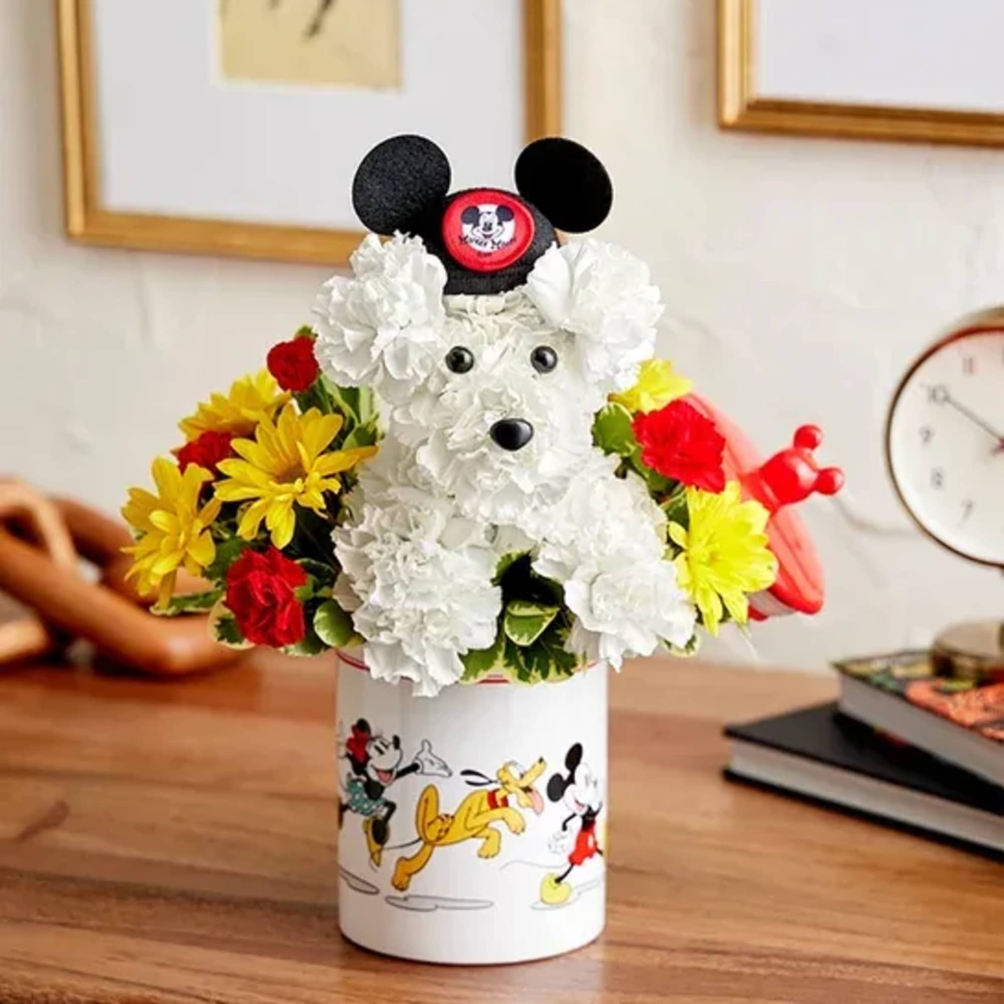Mickey Mouse-shaped floral arrangement in a Disney-themed container