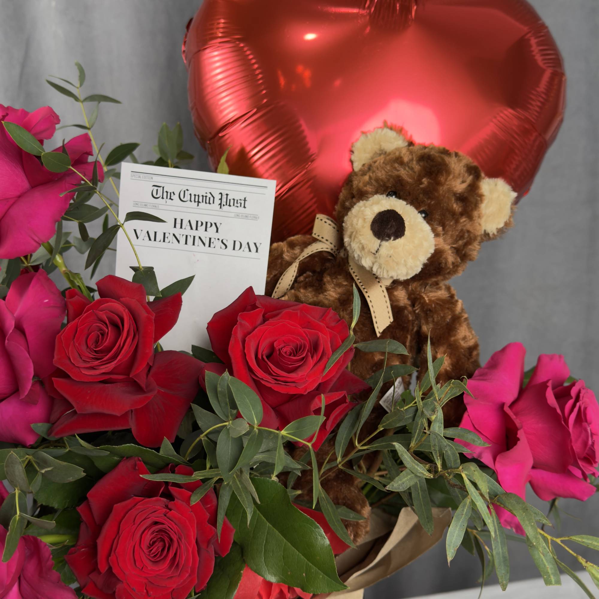 Red and pink roses with a teddy bear and heart balloon