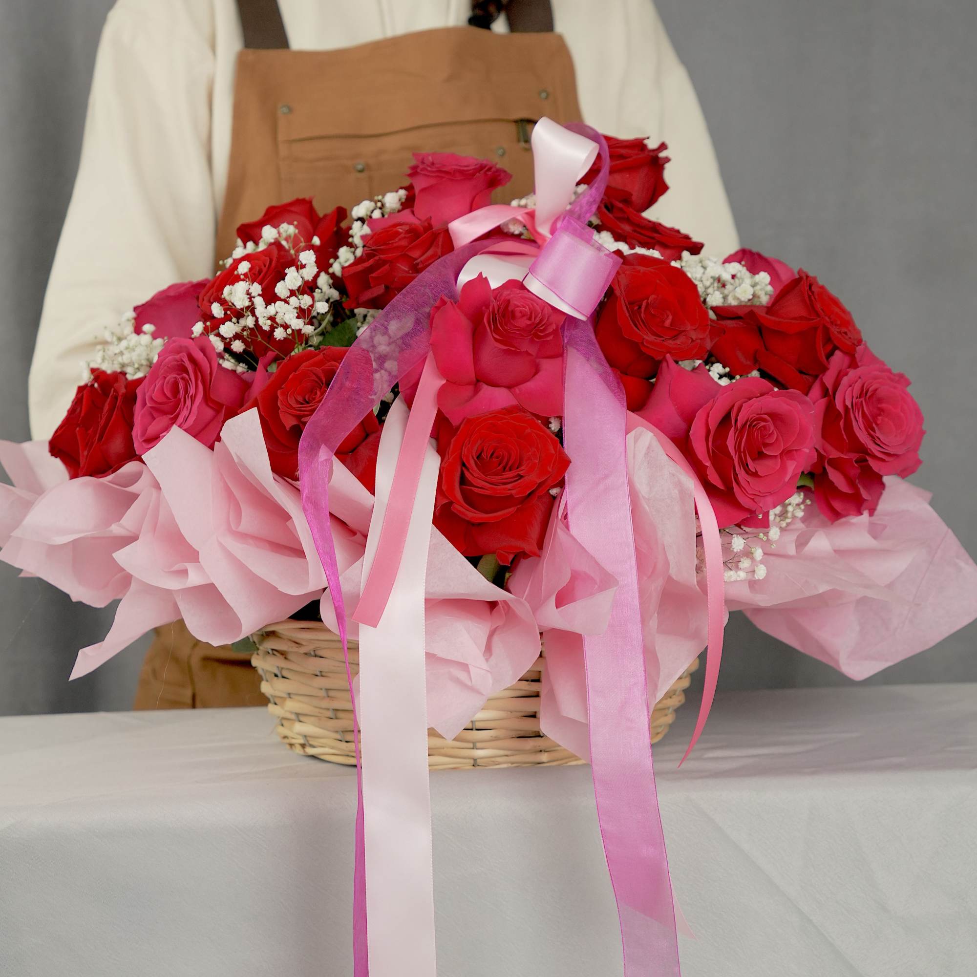 Basket of red and pink roses with pink ribbons, photo 2 of 4