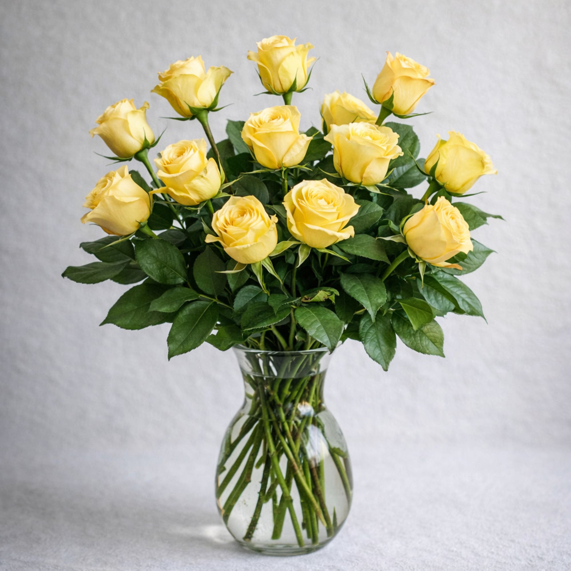Yellow roses arranged in a clear glass vase