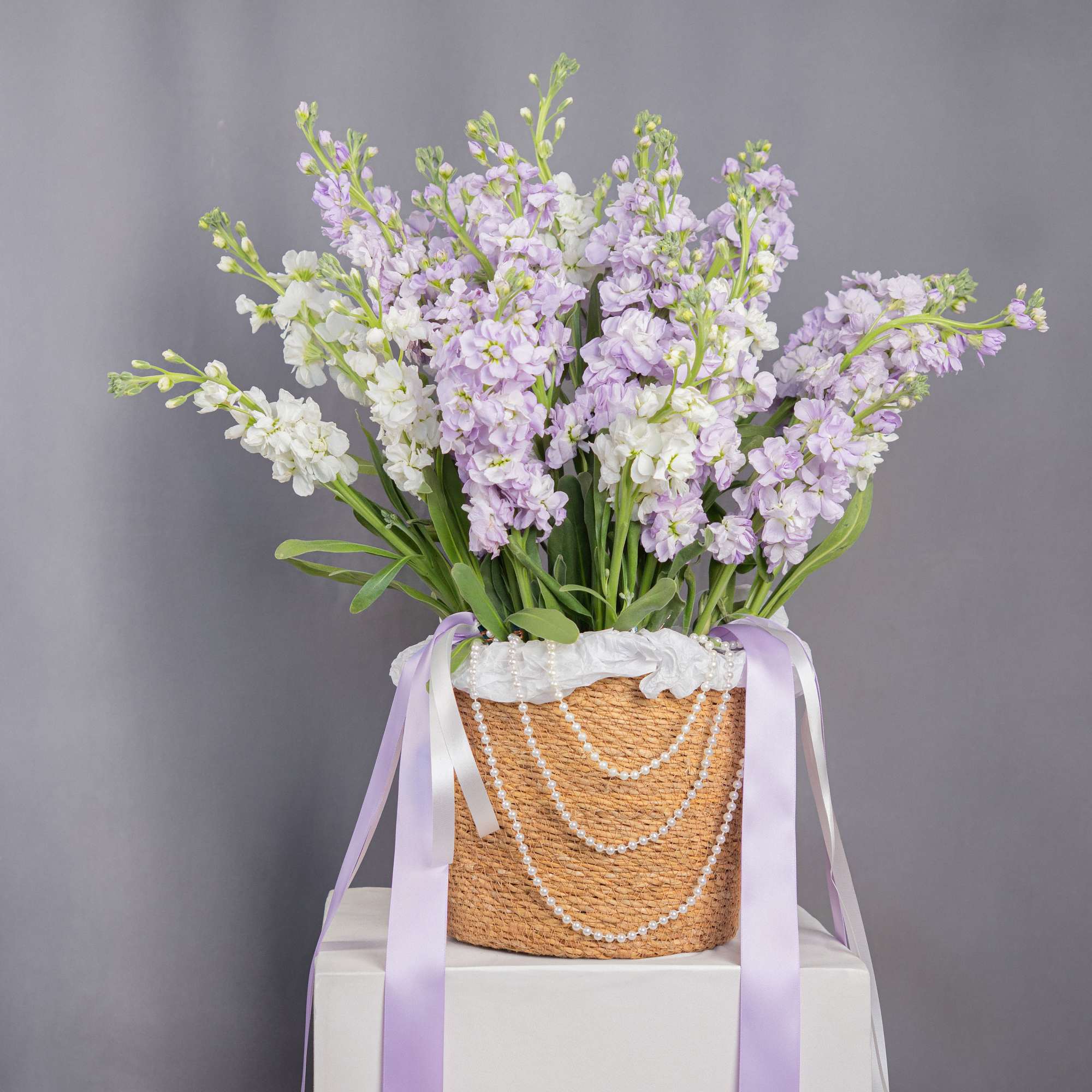 Inspired by regal romance, this delicate lavender arrangement evokes elegance, femininity, and