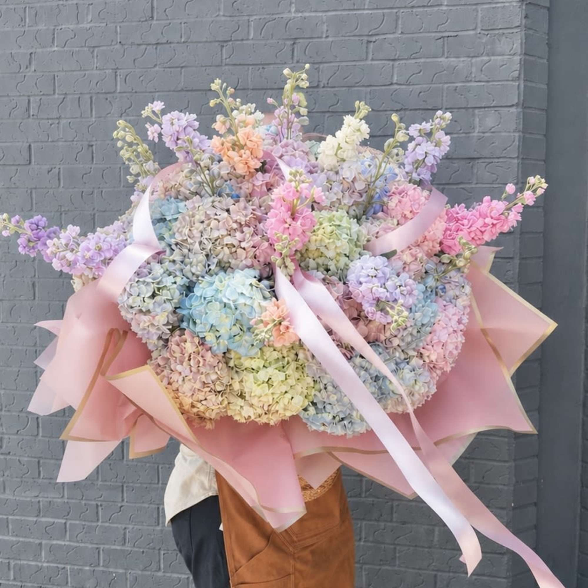An oversized, hand-held pastel bouquet that reads like a daydream-perfect as a