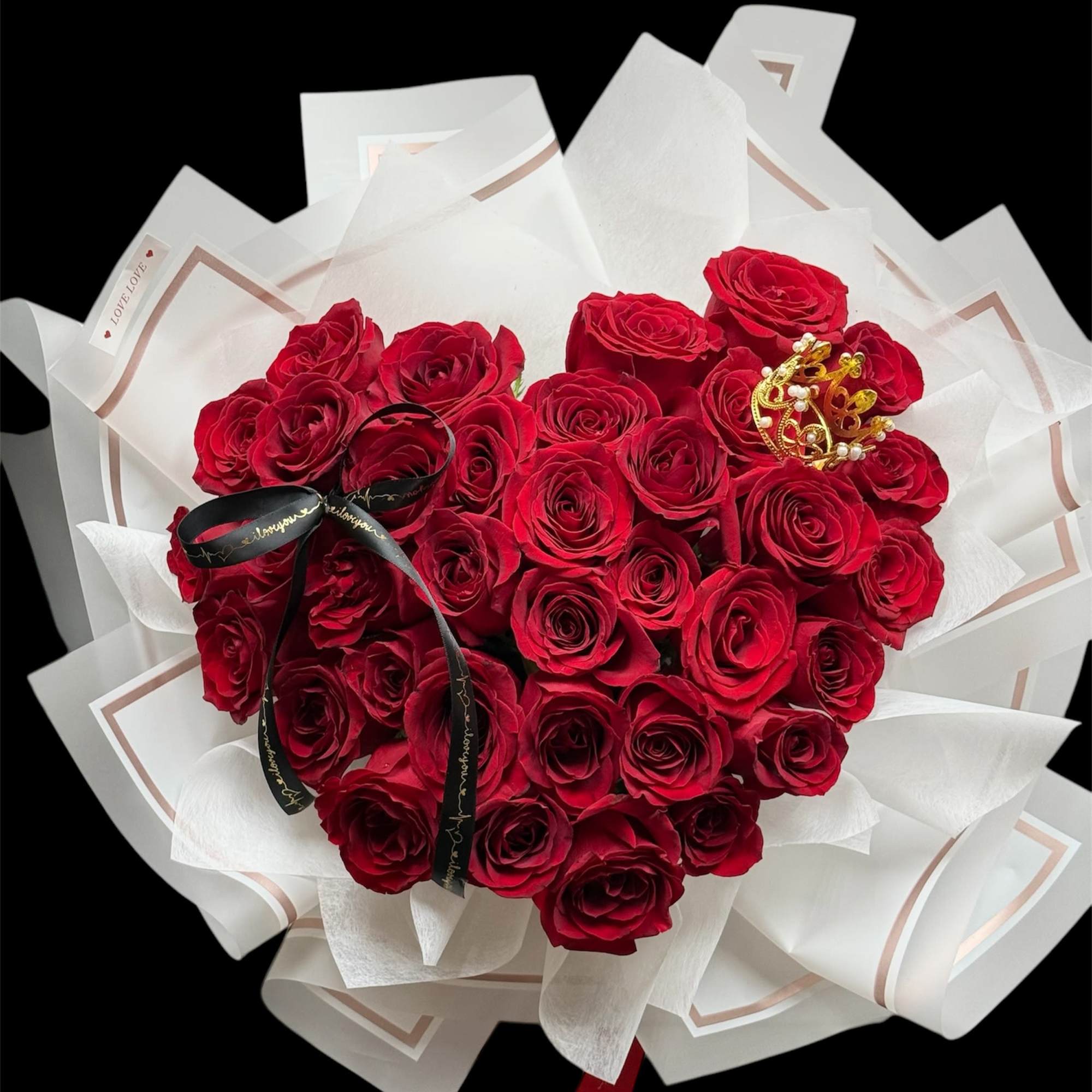 Heart-shaped bouquet of red roses wrapped in white paper, photo 2 of 3