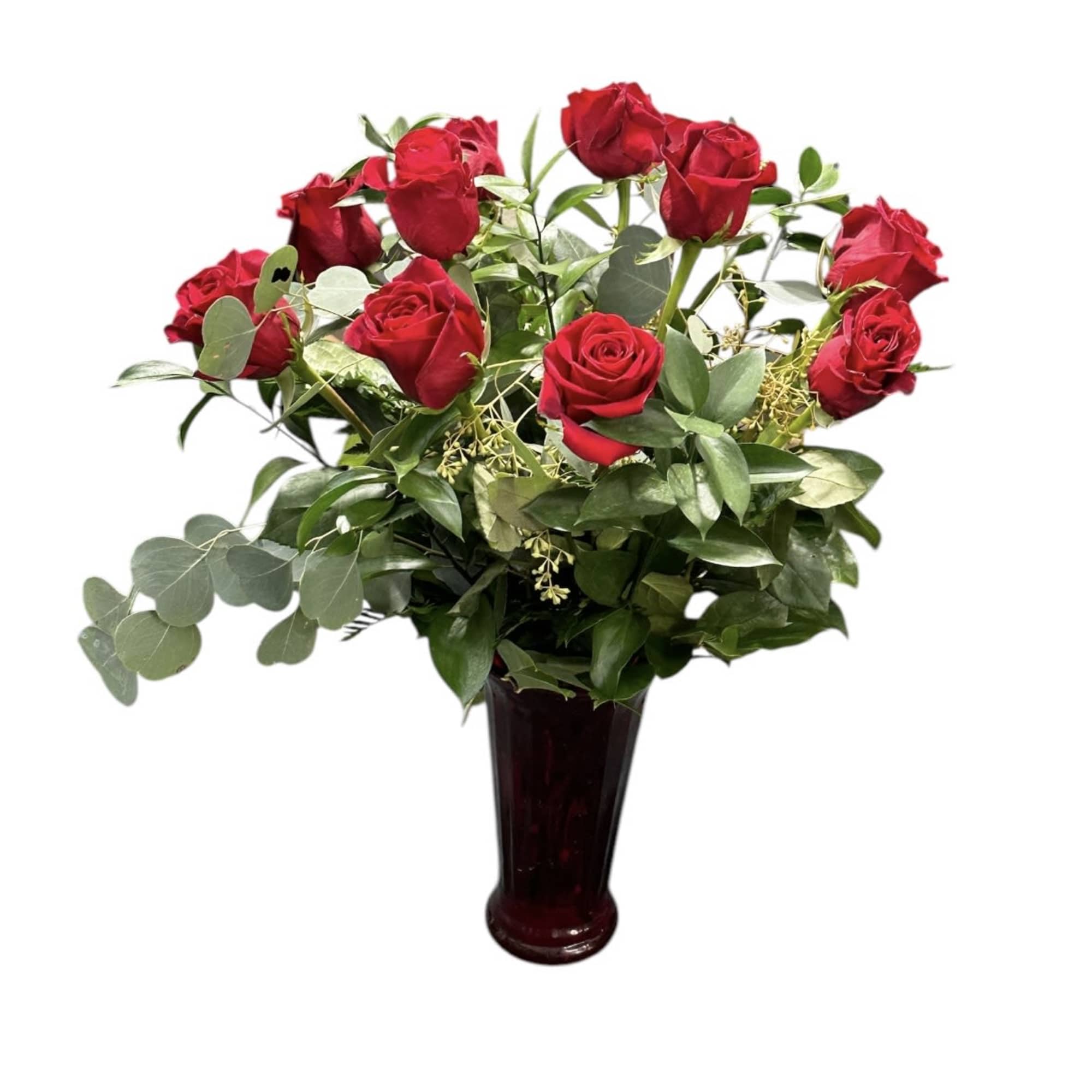 Red roses arranged in a dark vase with mixed greenery