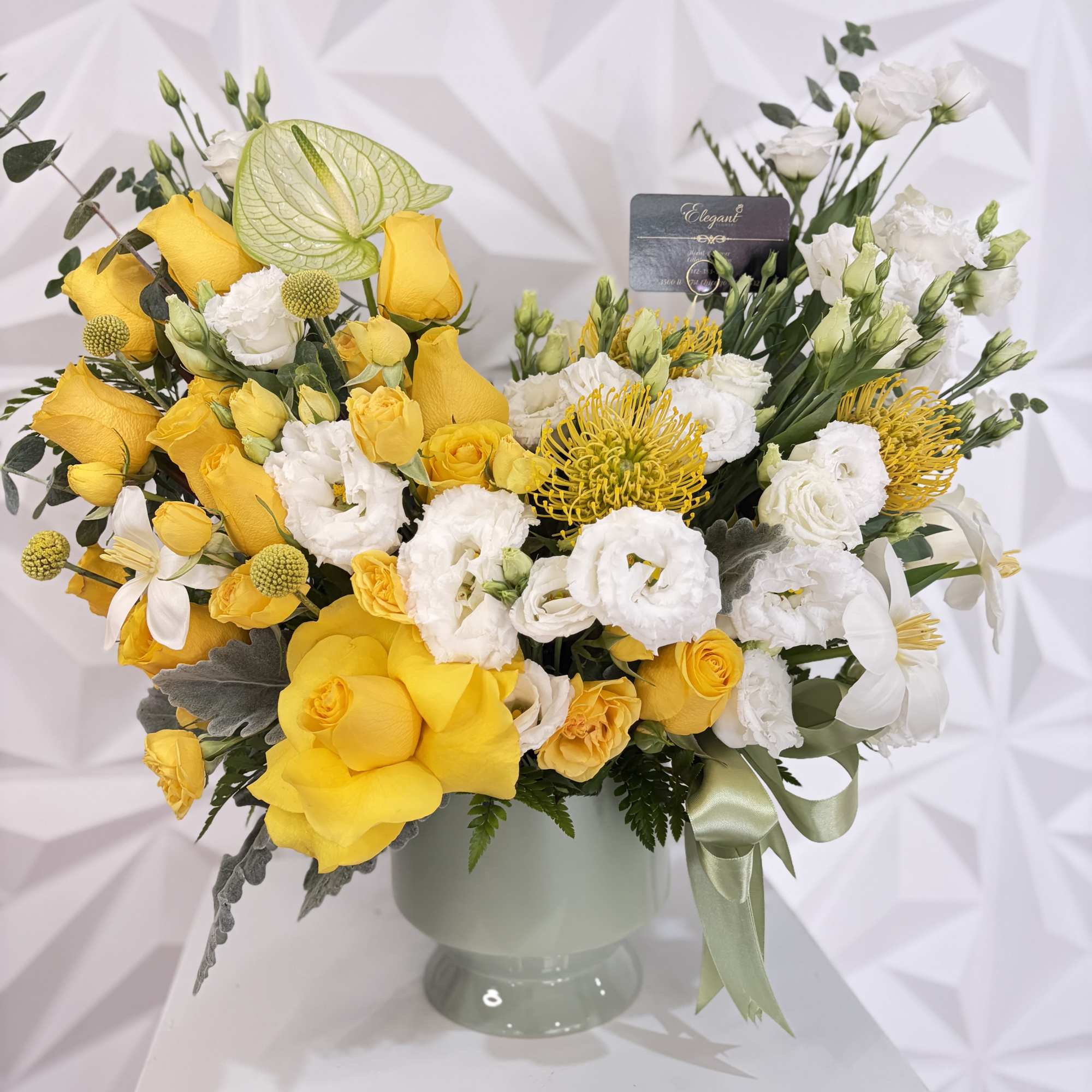 This sophisticated floral arrangement is beautifully designed in an elegant ceramic vase