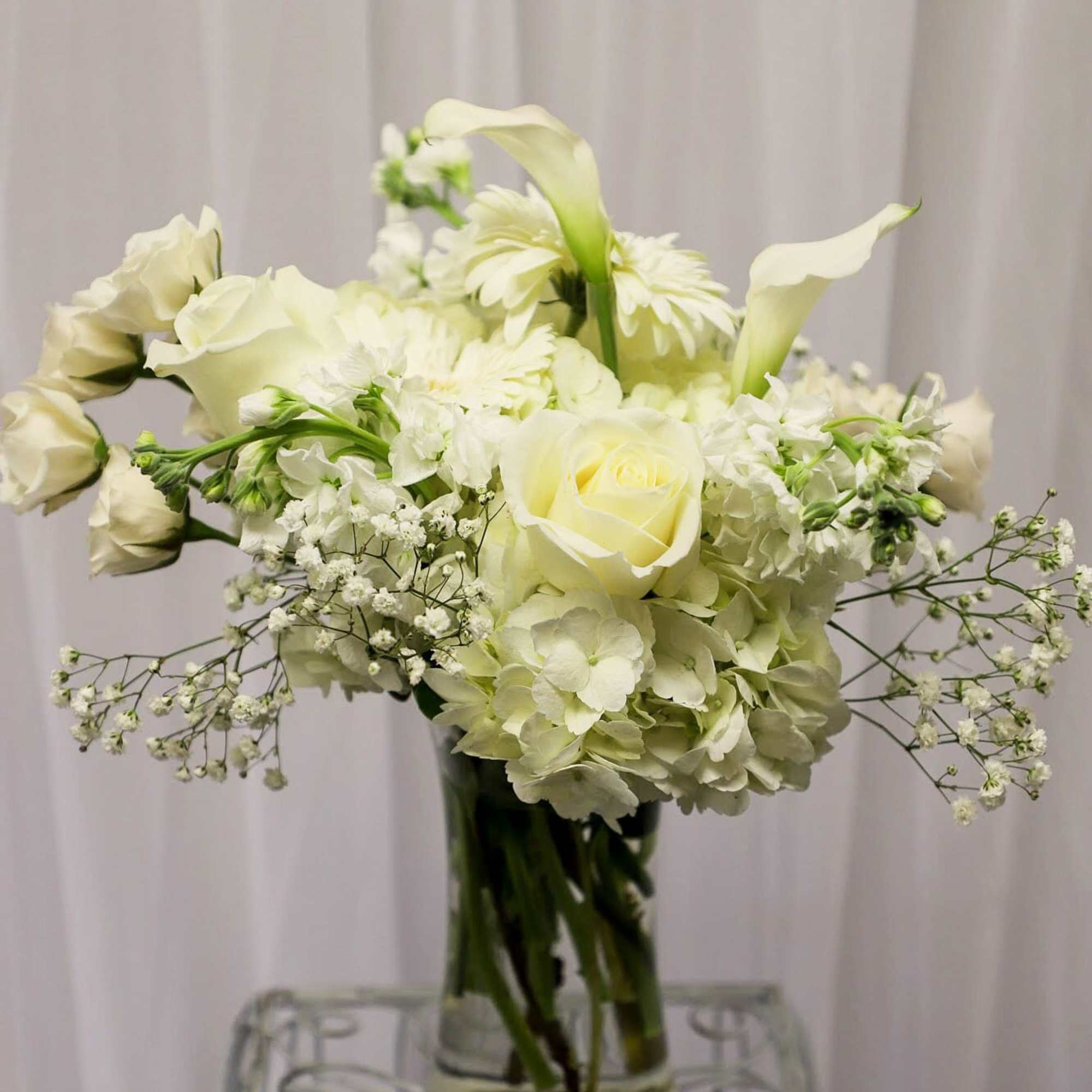 White floral arrangement in a clear glass vase