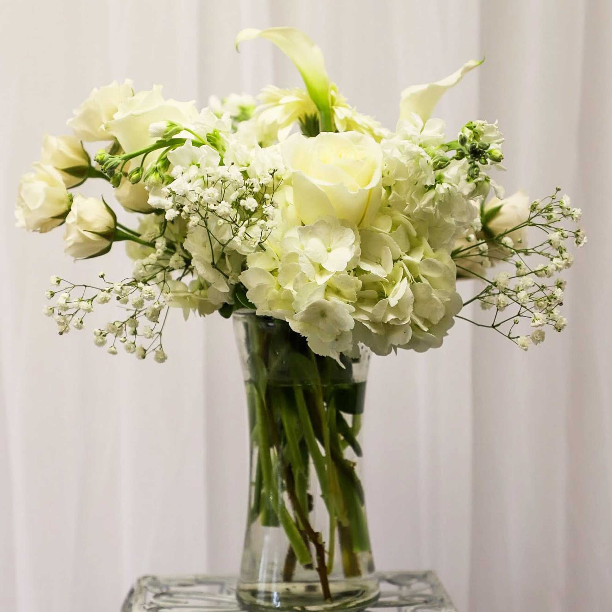 White floral bouquet in a clear glass vase