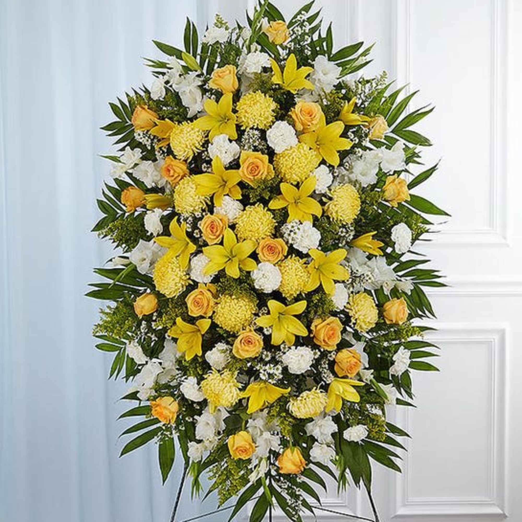 Large standing floral spray with yellow and white flowers on an easel