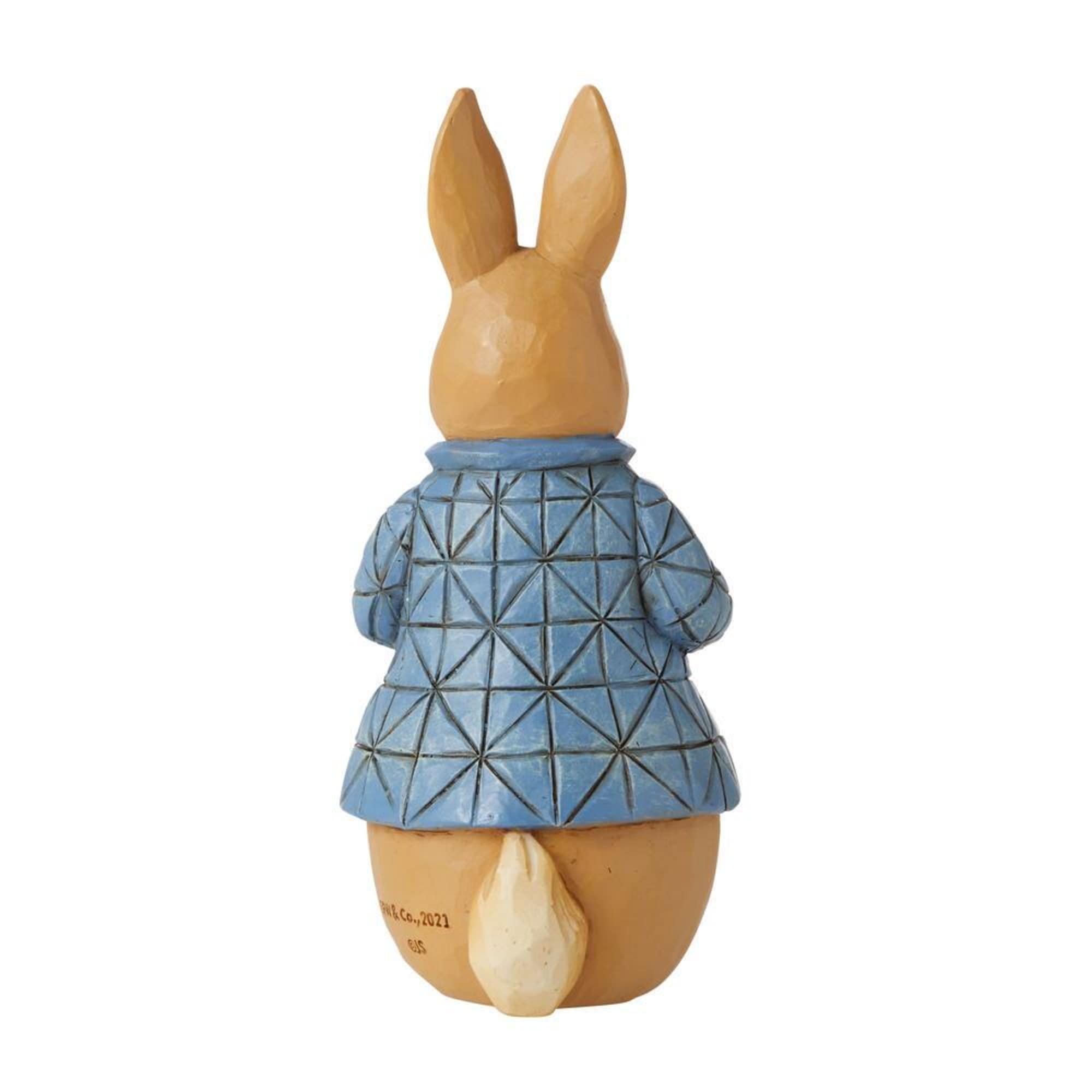 Wooden rabbit figurine in a blue patterned coat