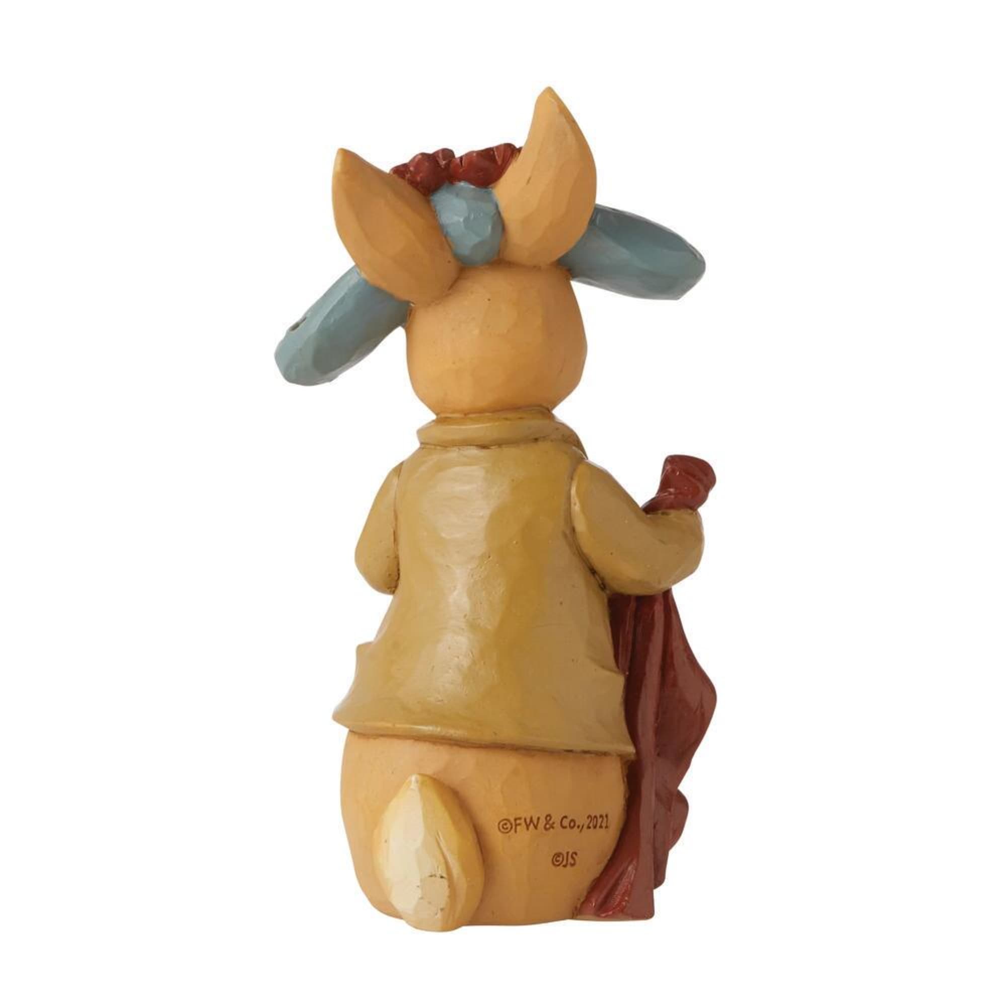 Small painted figurine of a fox holding a cloth