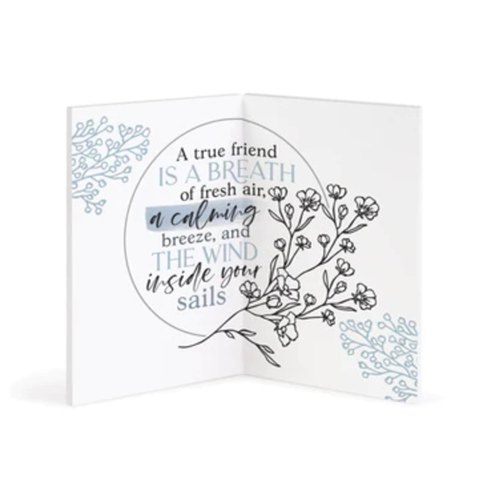 Folded greeting card with floral line art and a friendship quote