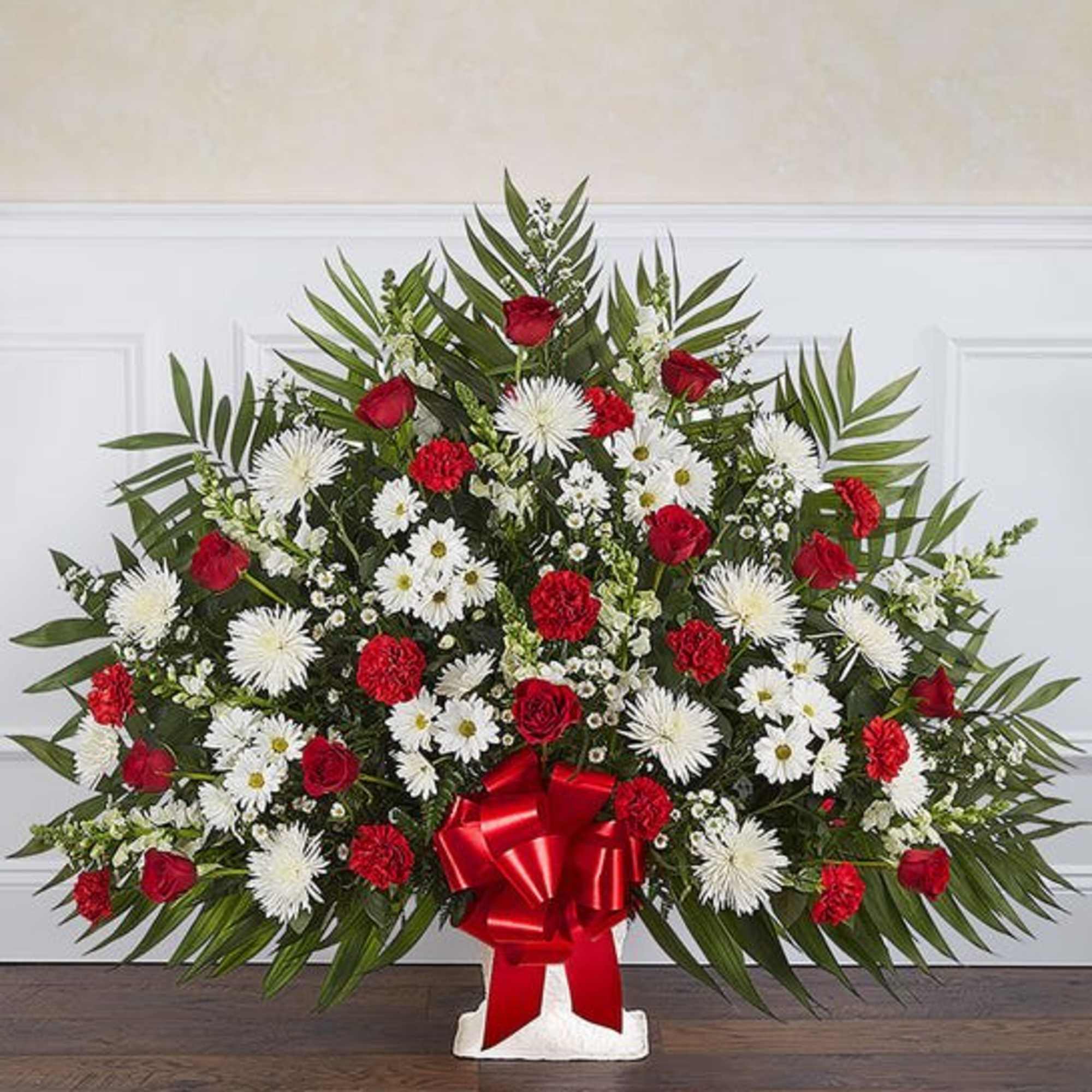 Large red and white floral spray with a red ribbon bow