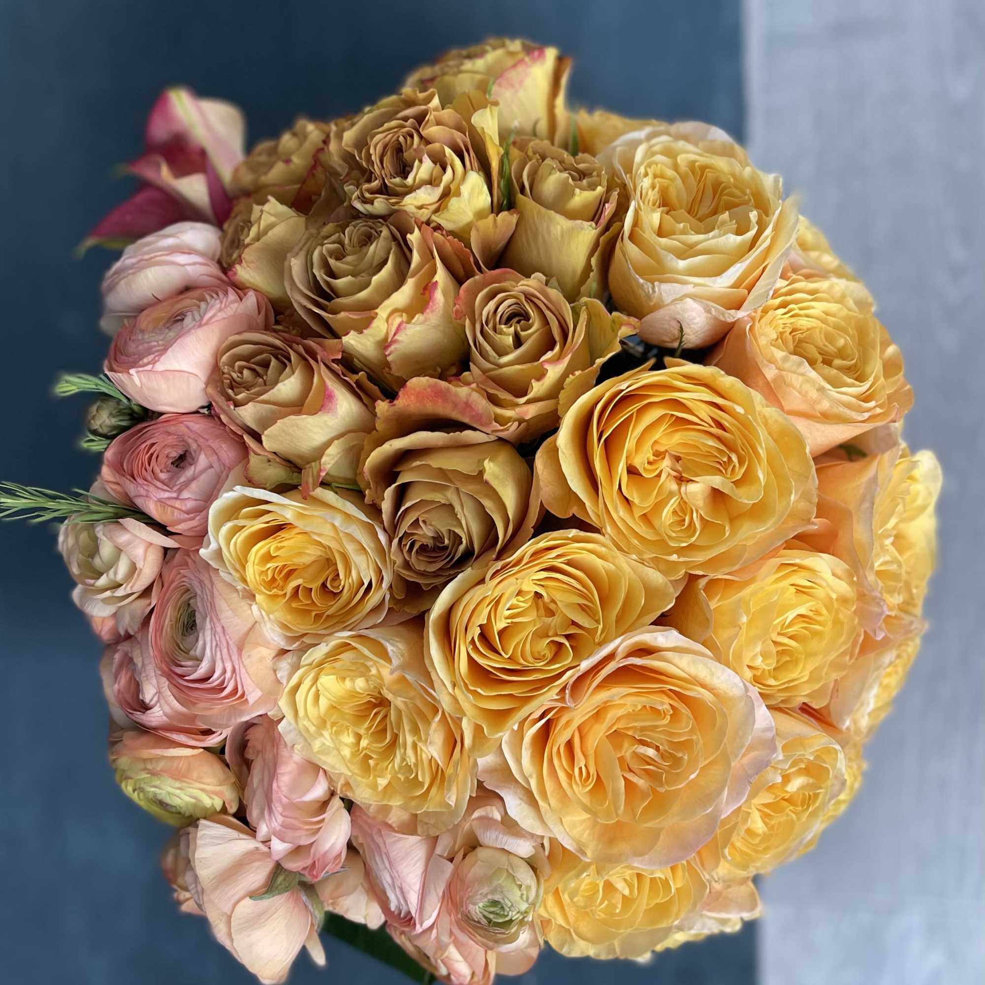 Round bouquet of yellow and blush roses