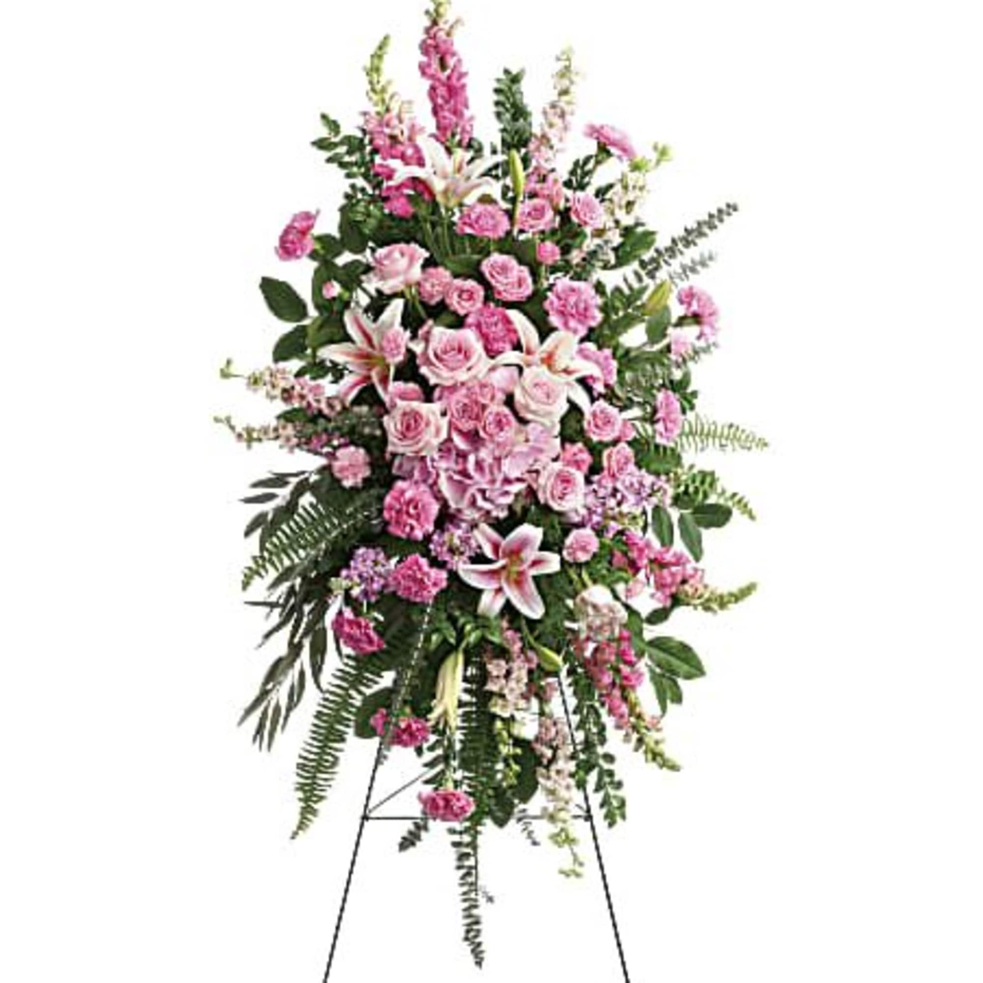 Tall pink standing spray with roses, lilies, and carnations on a black easel.
