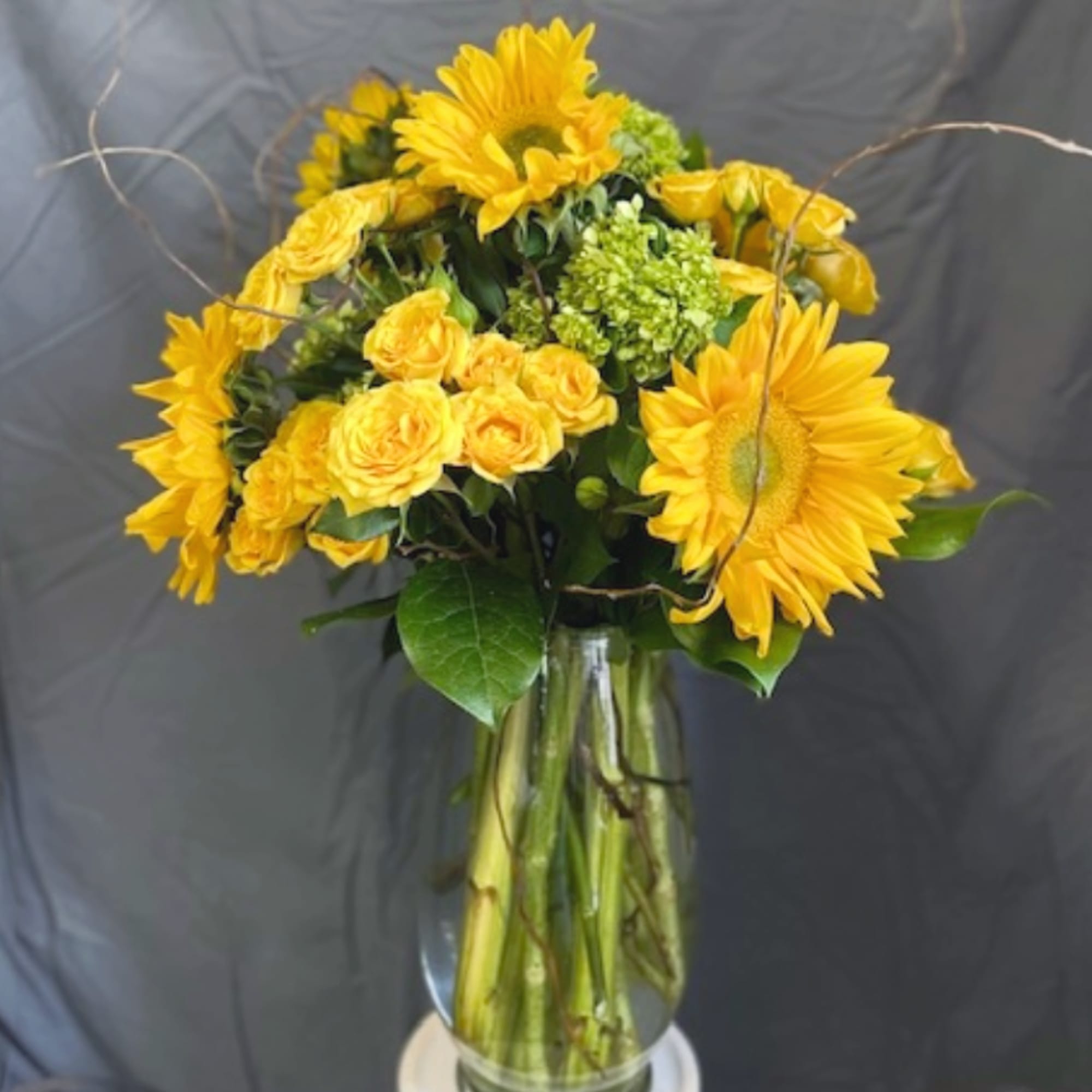 You will love this happy and bright arrangement featuring one of summer's