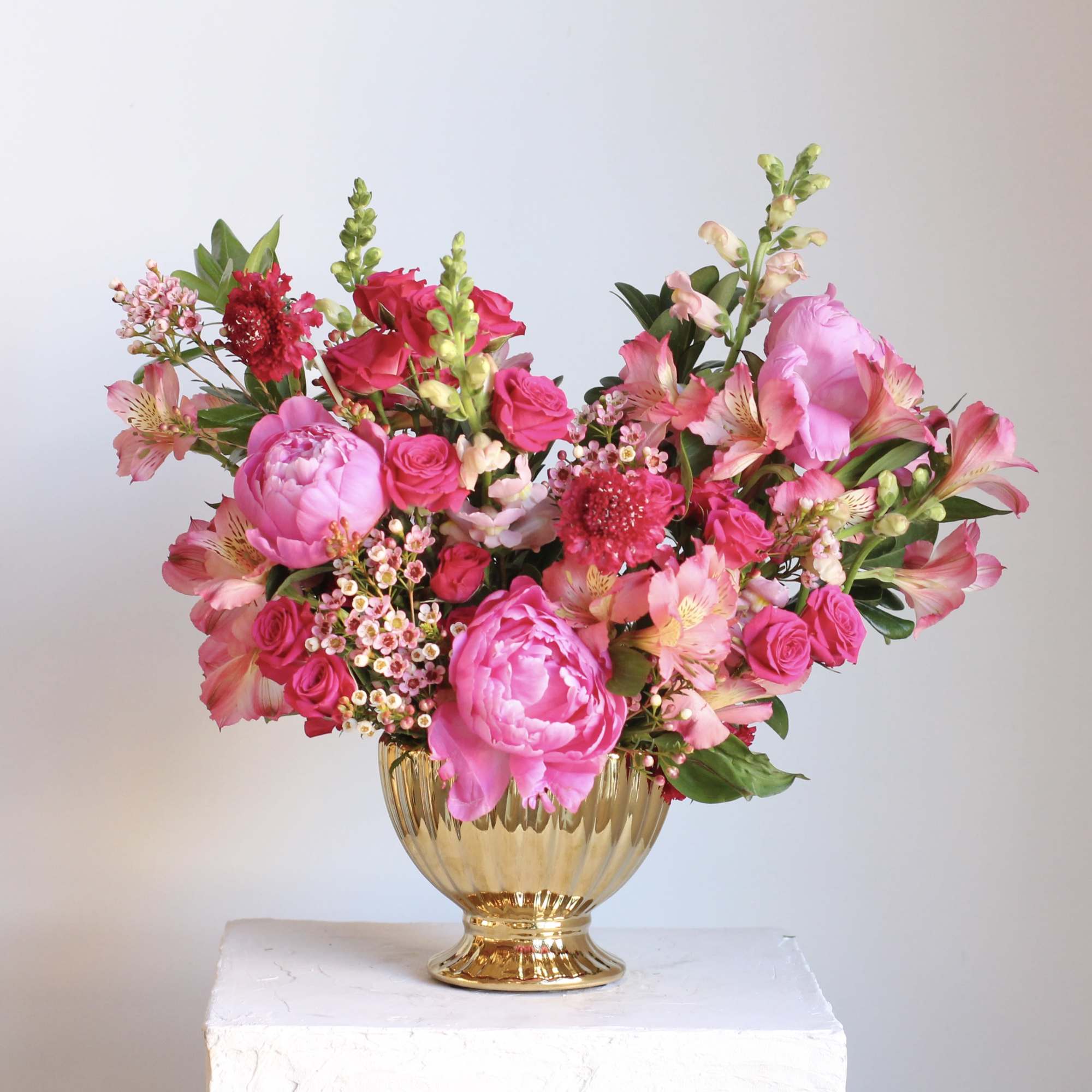 Pink floral arrangement in a gold vase, photo 3 of 3