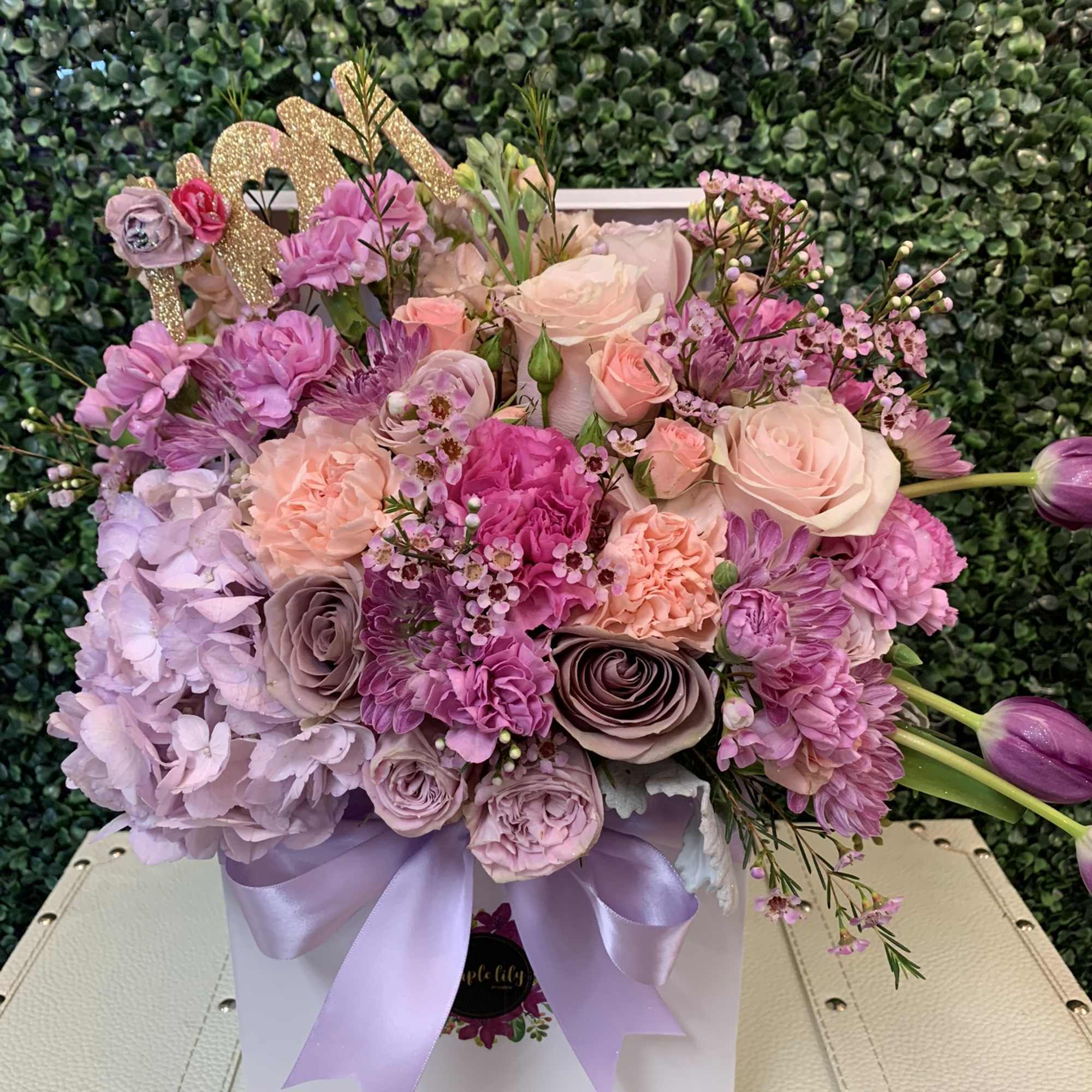 Pink and lavender bouquet in a white box with a satin ribbon