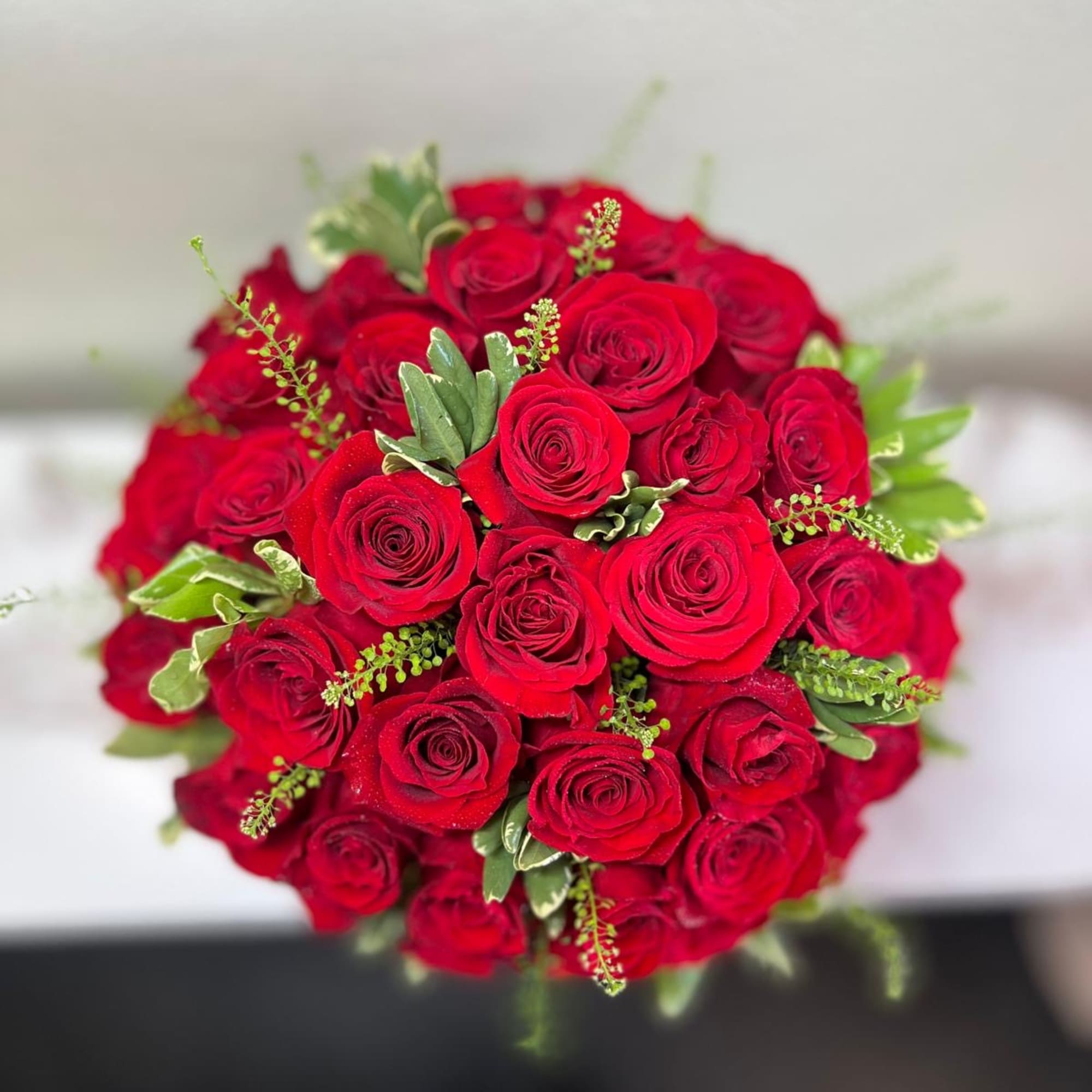 Bouquet of red roses with green foliage