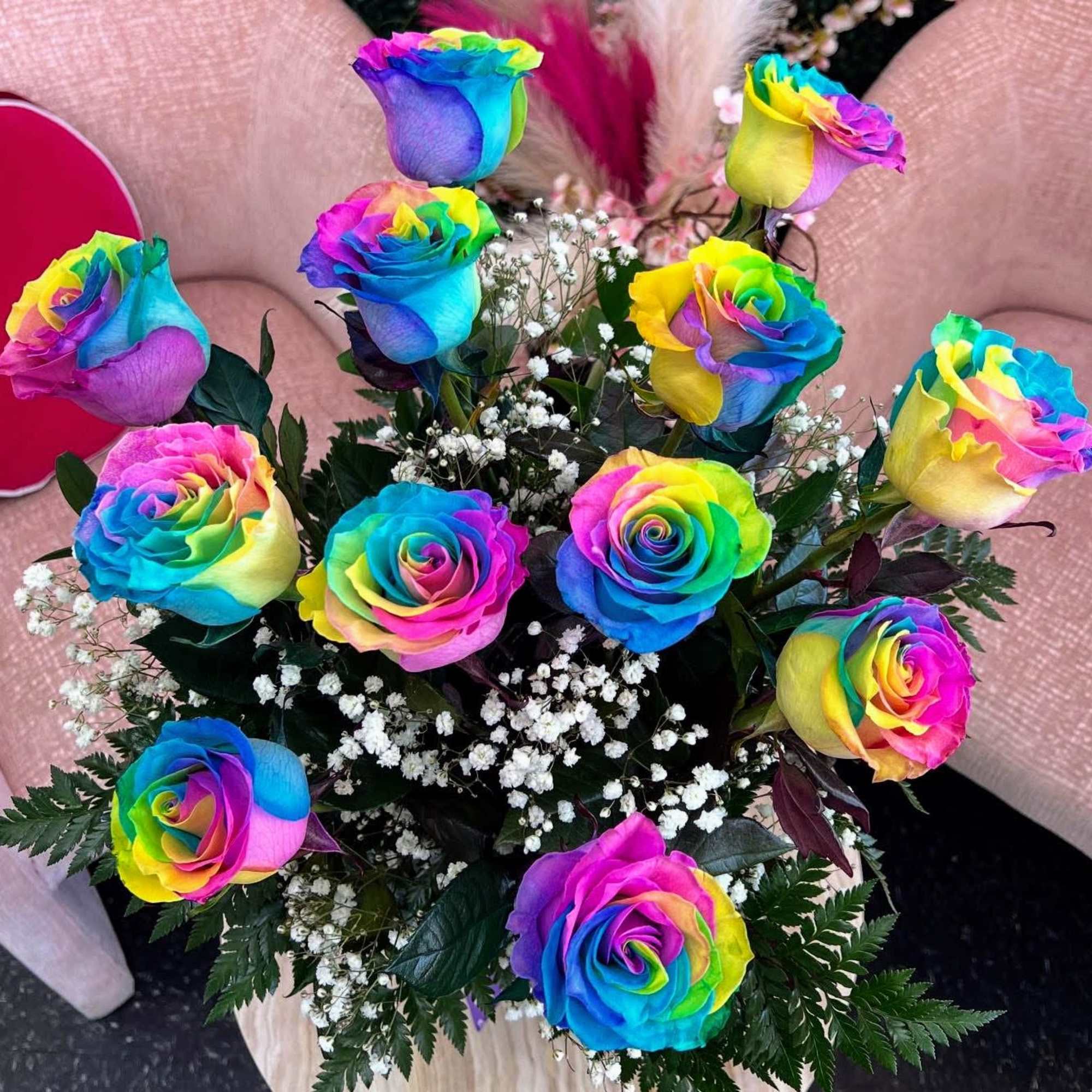Bouquet of rainbow-colored roses with white baby's breath