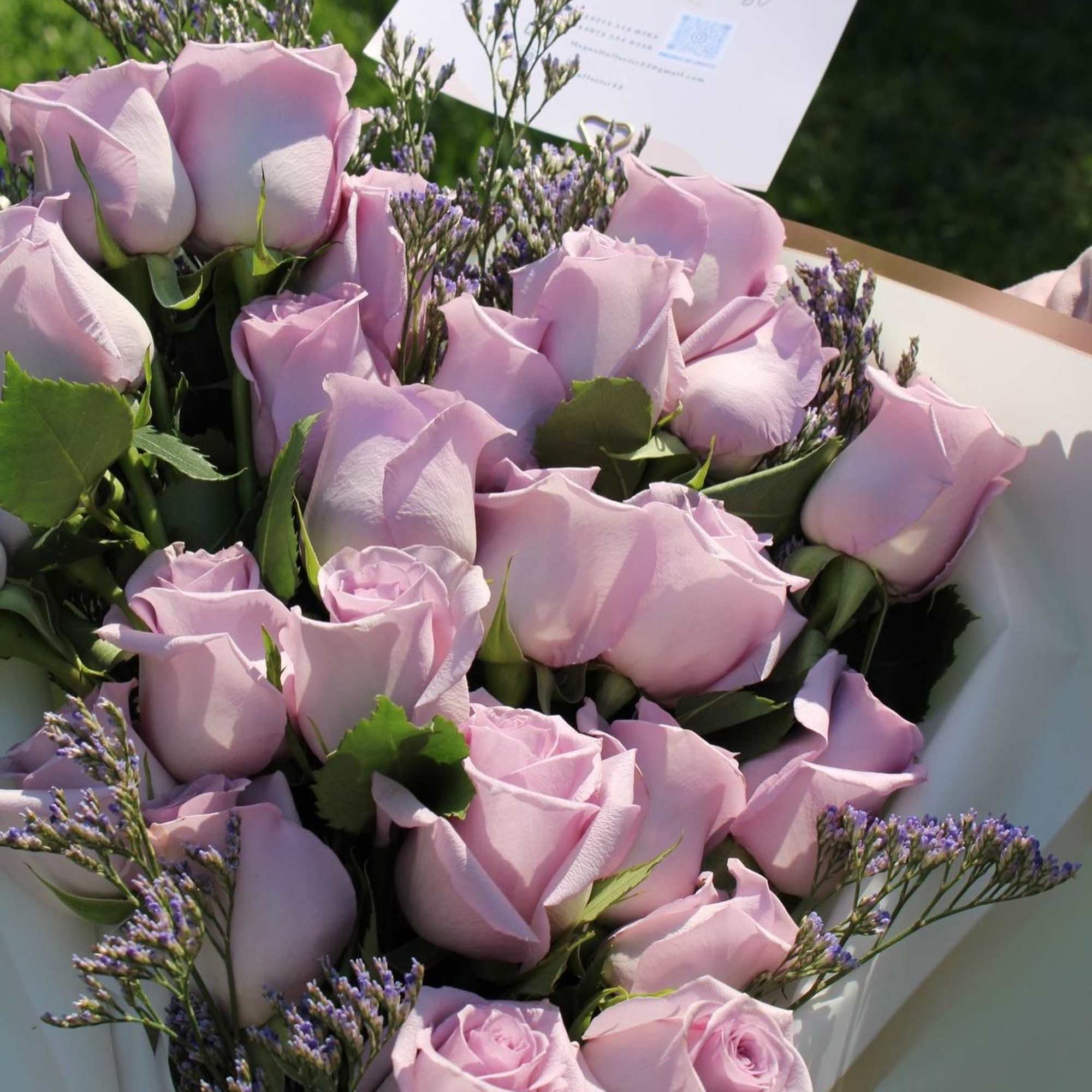 Bouquet of pale pink roses with purple filler flowers