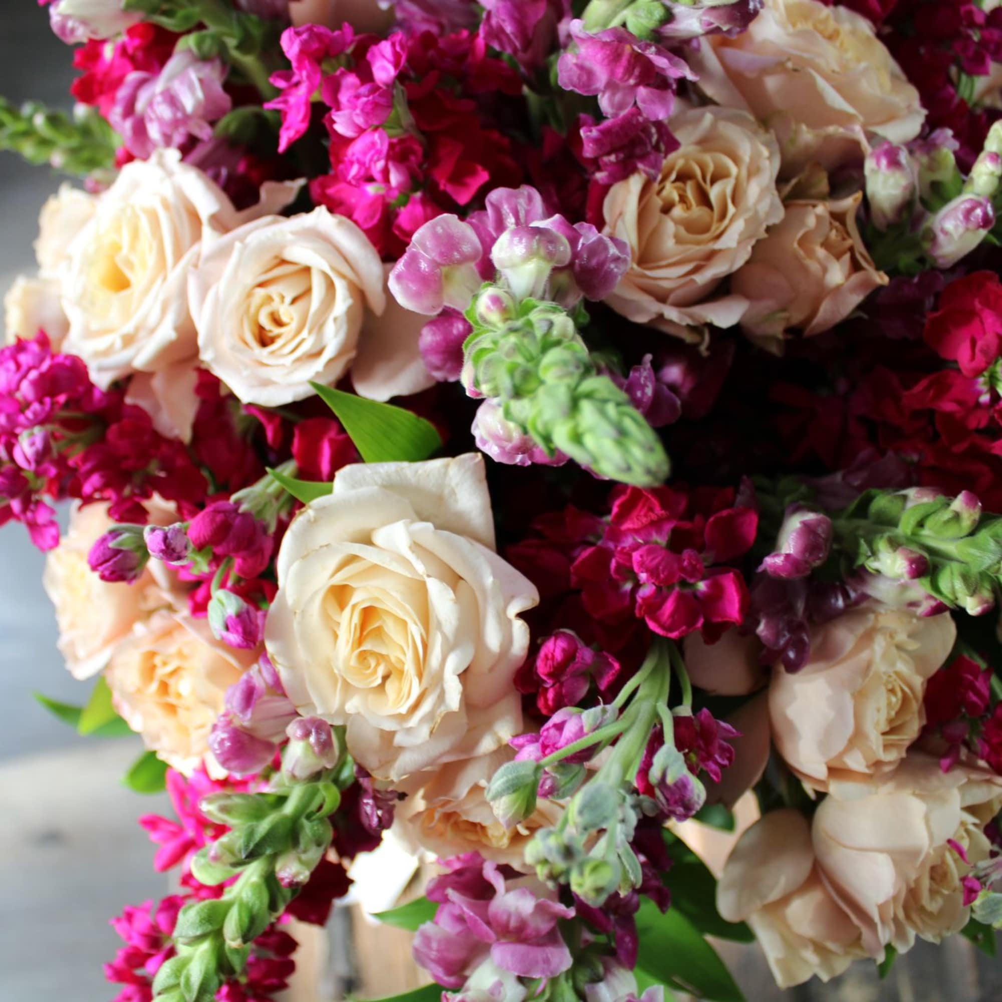 Bouquet of cream roses and bright pink flowers