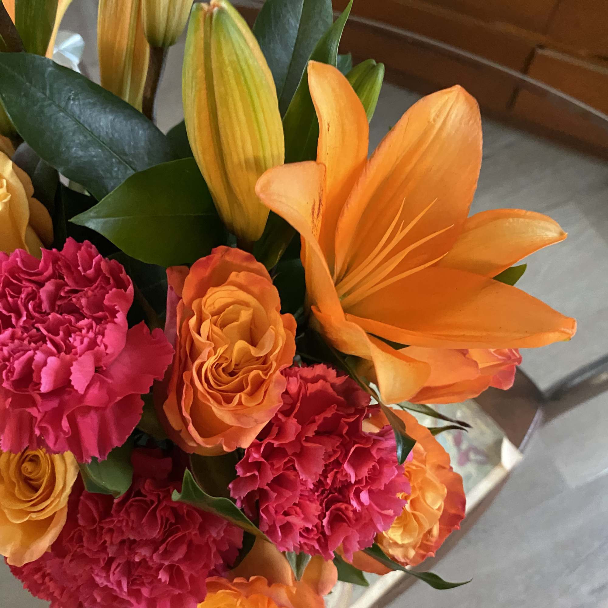 Bouquet of orange lilies and pink carnations with orange roses
