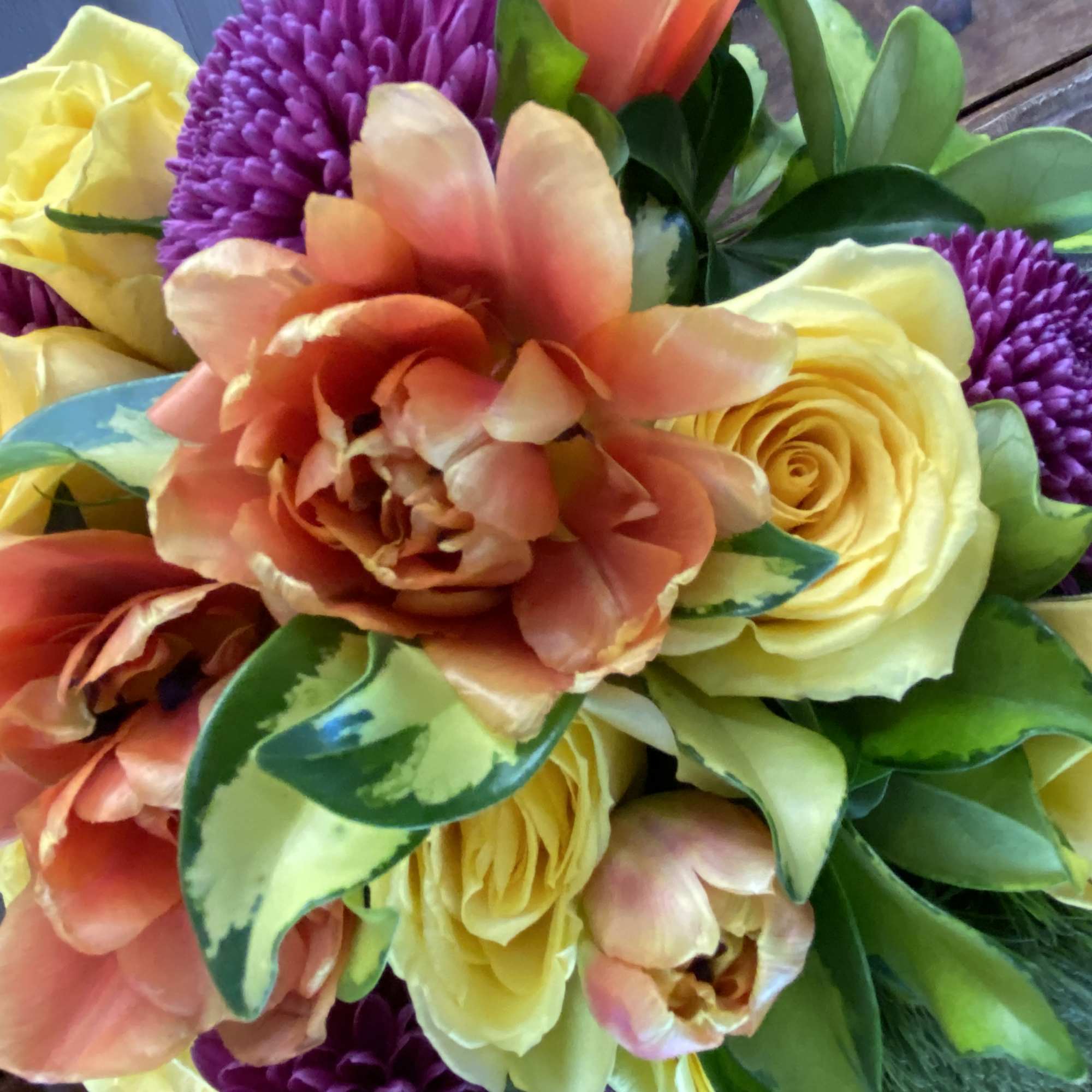 Bouquet of yellow roses, peach tulips, and purple mums