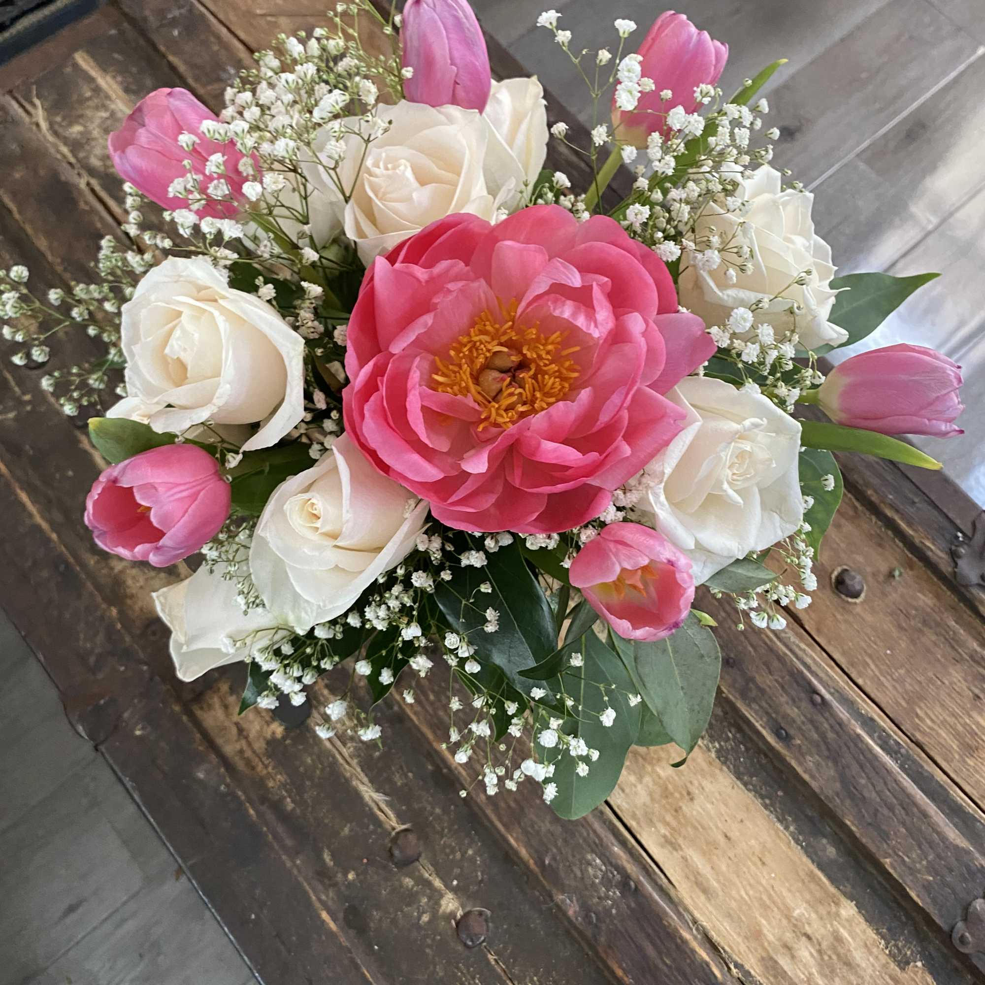 Bouquet of pink tulips, white roses, and a large pink peony