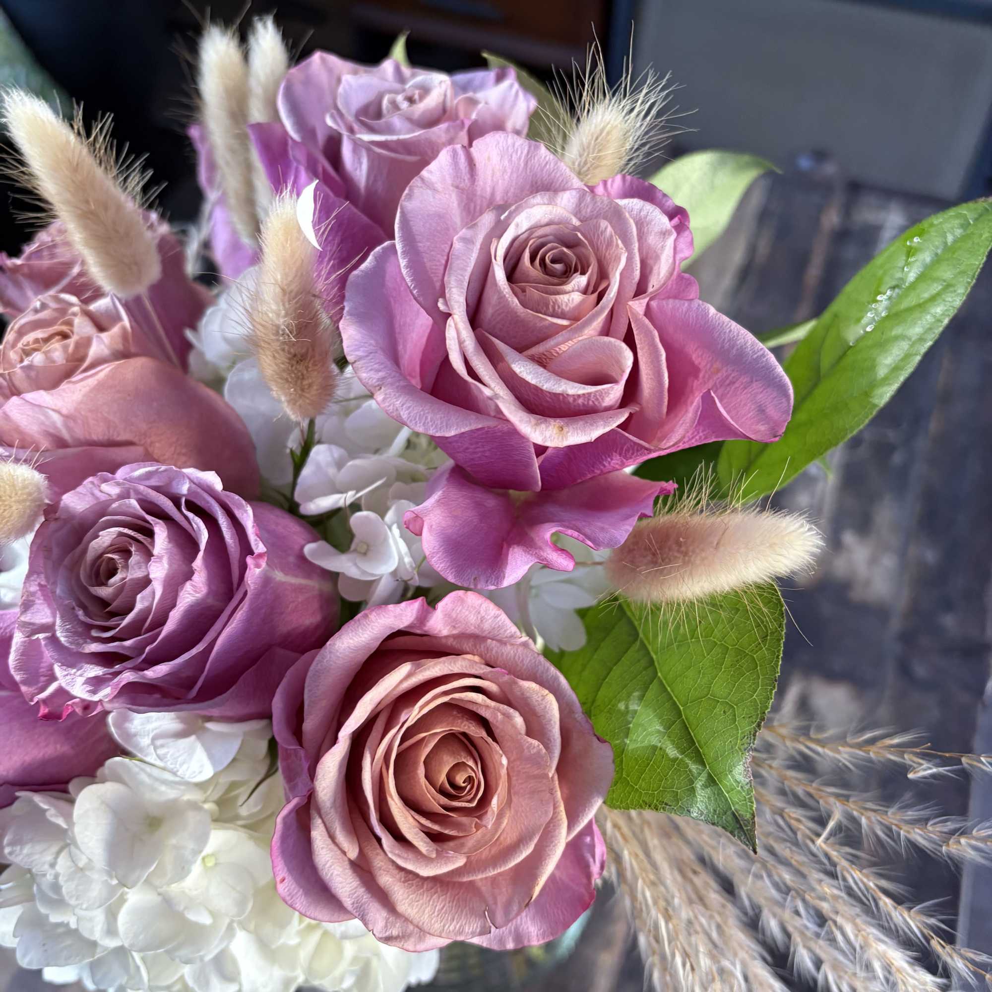 Pink and lavender roses with white hydrangea and dried bunny tails