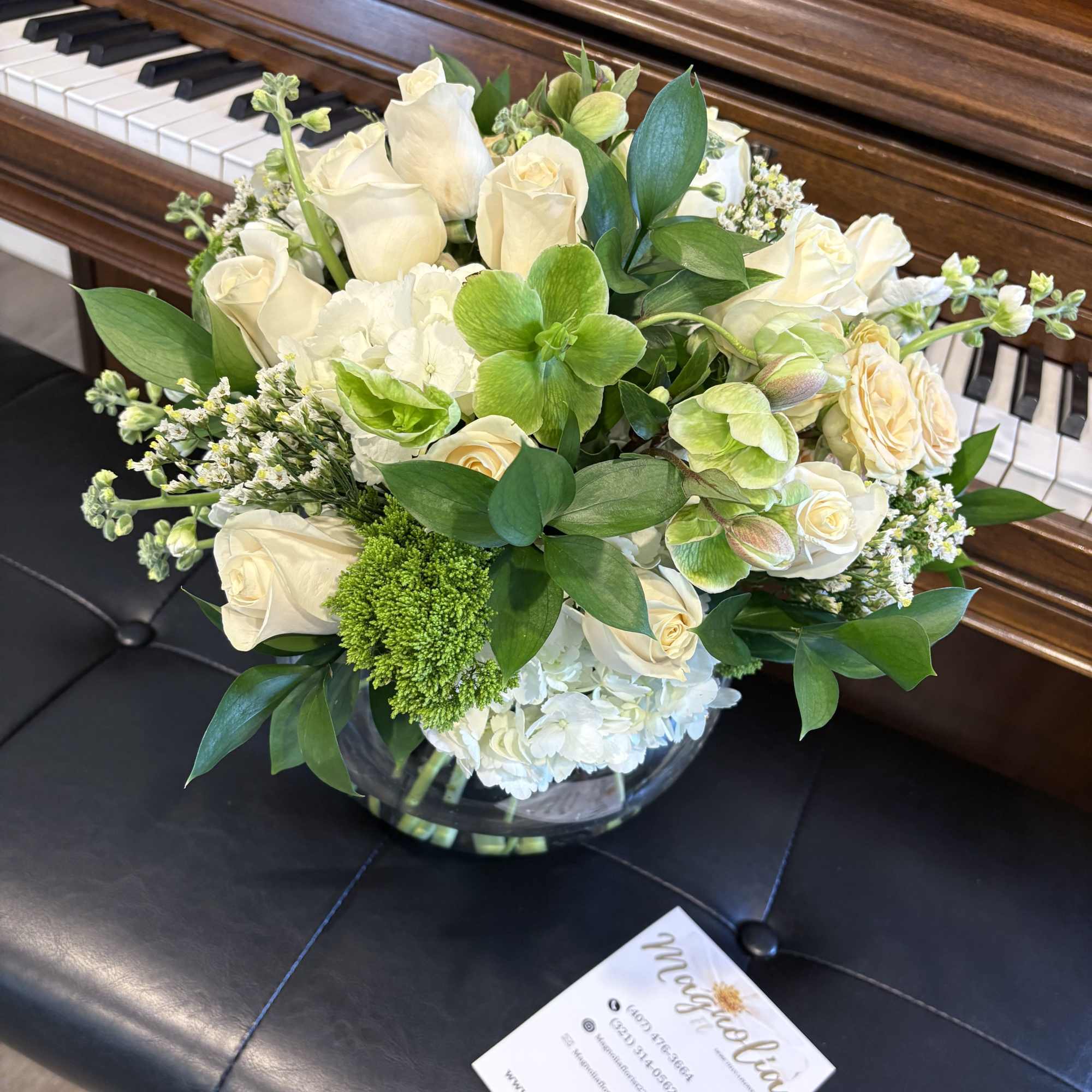 White rose and hydrangea arrangement in a glass bowl vase