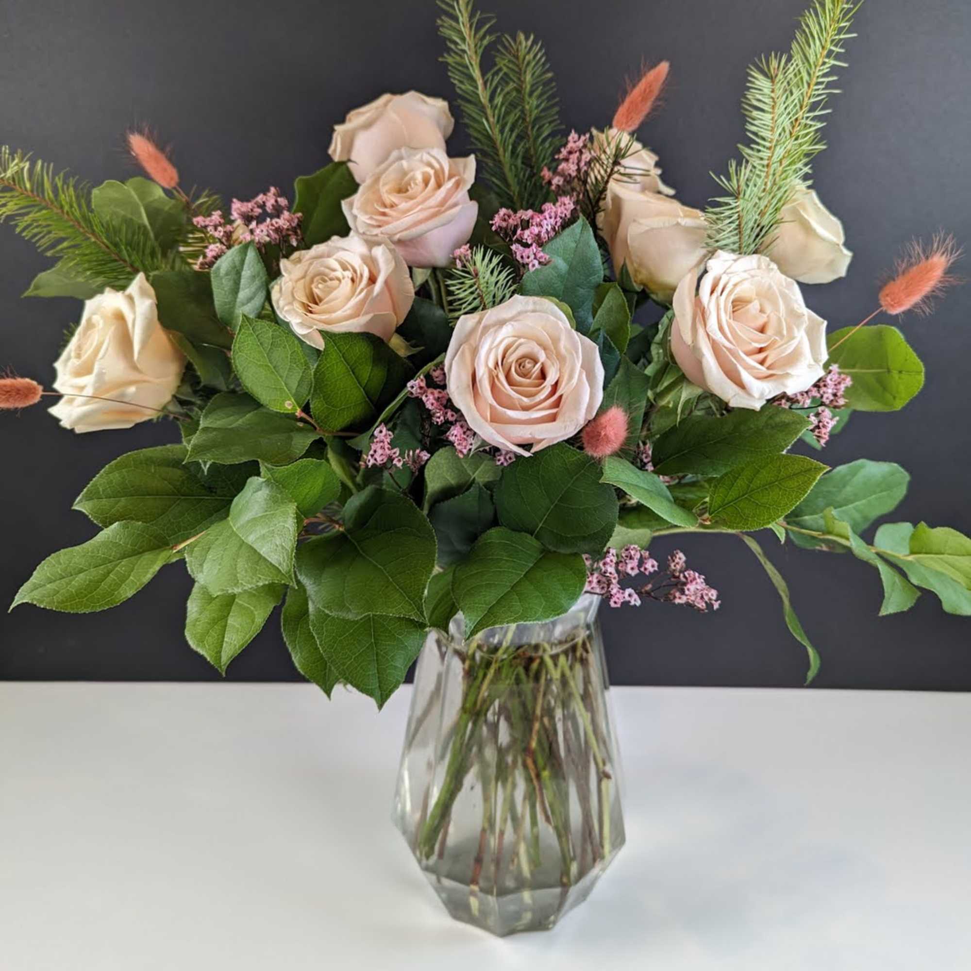 Bouquet of pale blush roses in a clear glass vase