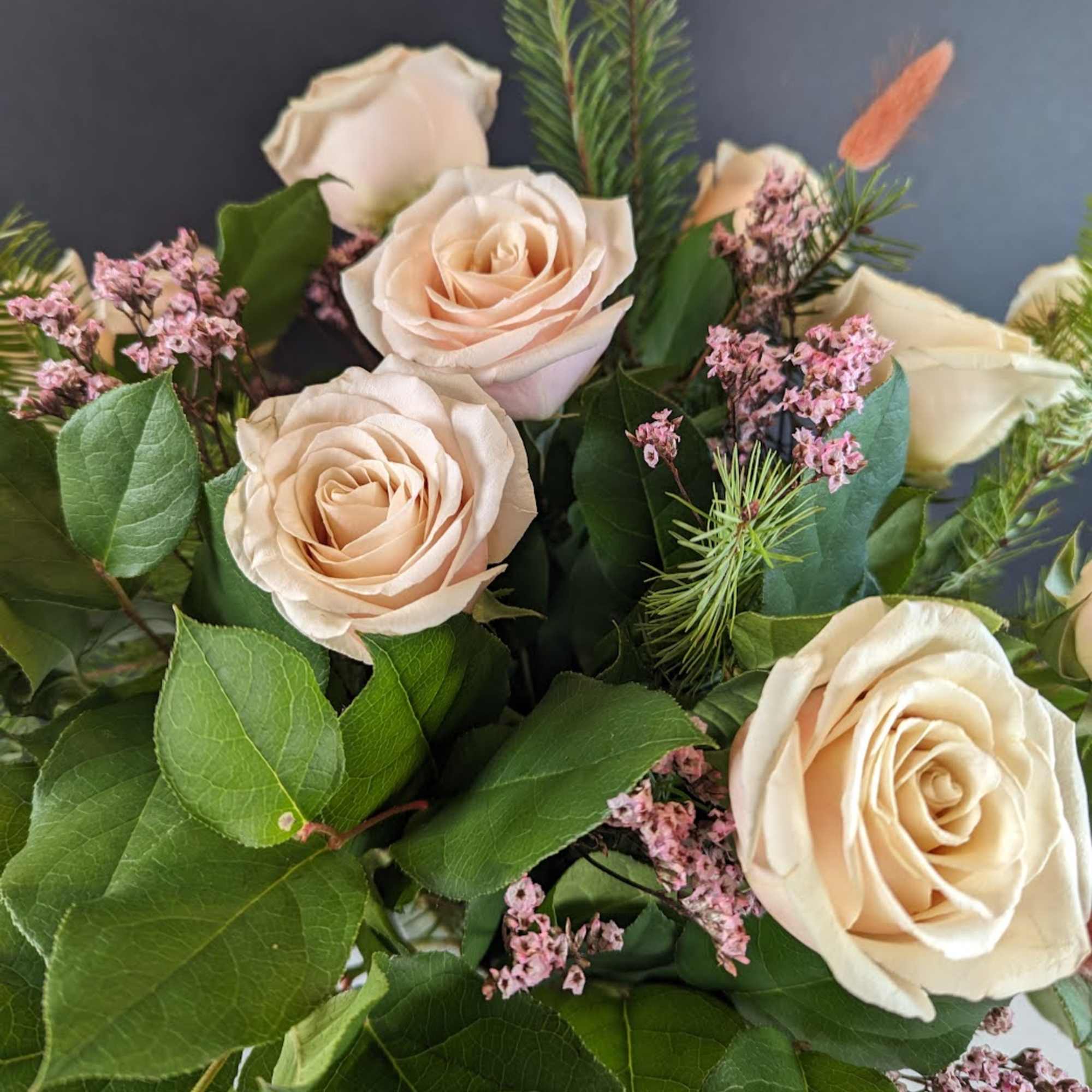 Bouquet of pale peach roses with pink filler flowers