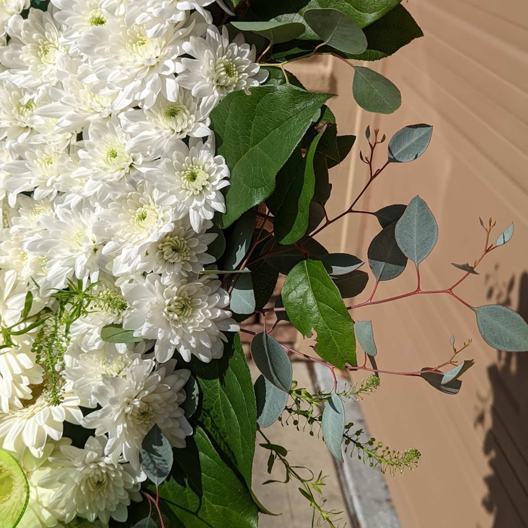 White chrysanthemum bouquet with eucalyptus and green wrap
