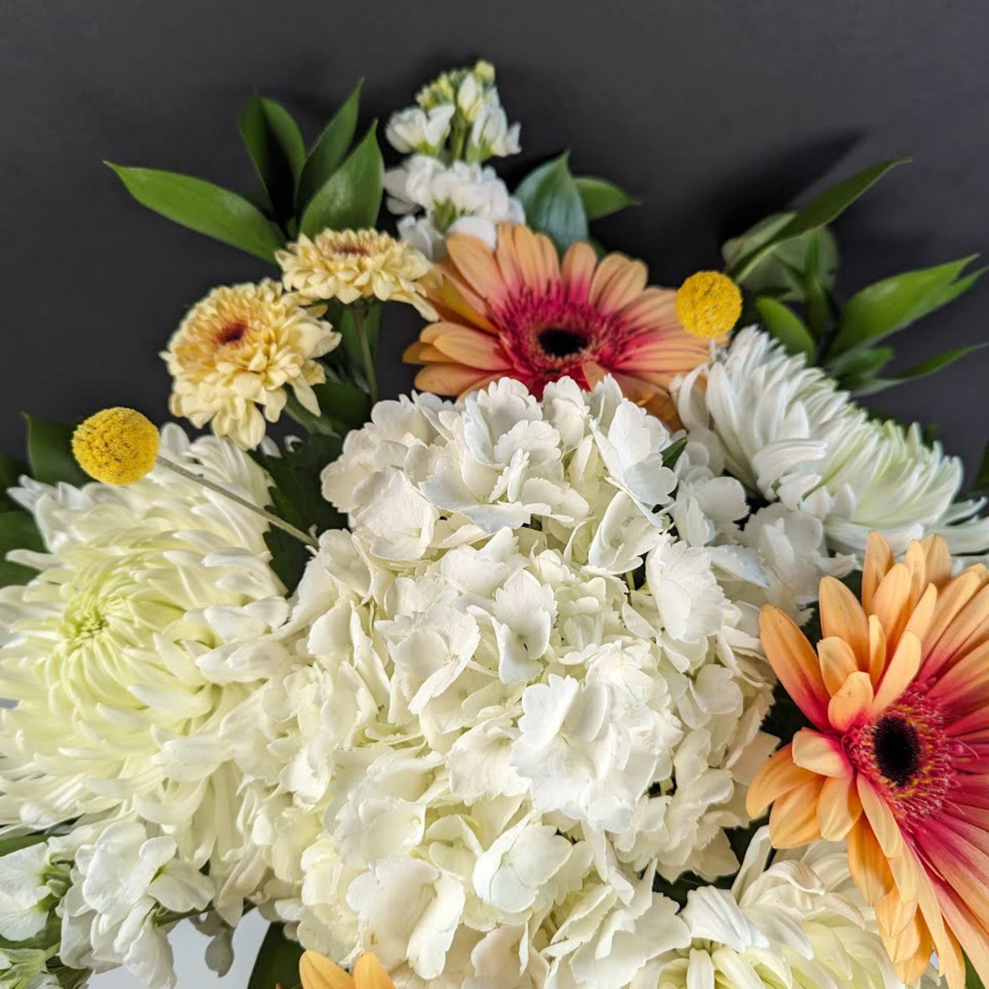 Bouquet of white hydrangea and orange gerbera daisies