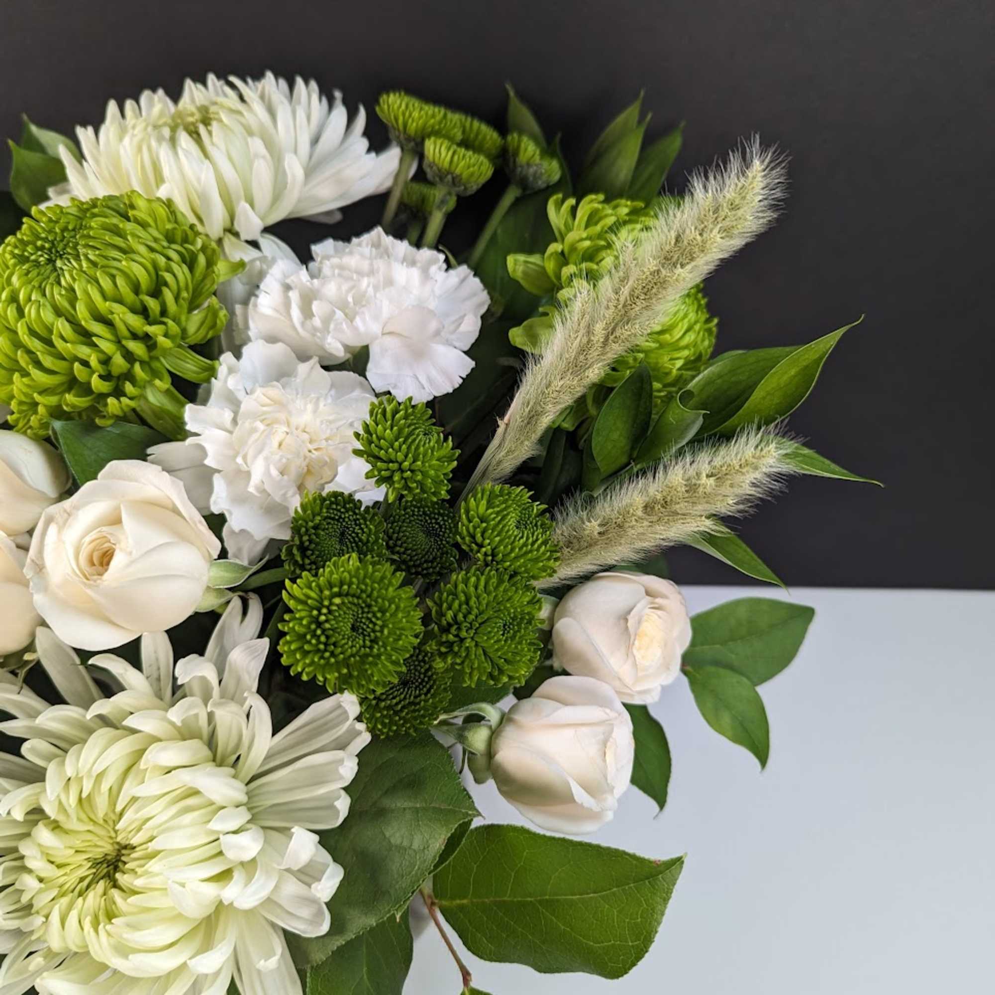 White and green bouquet with chrysanthemums, roses, and foxtail grass