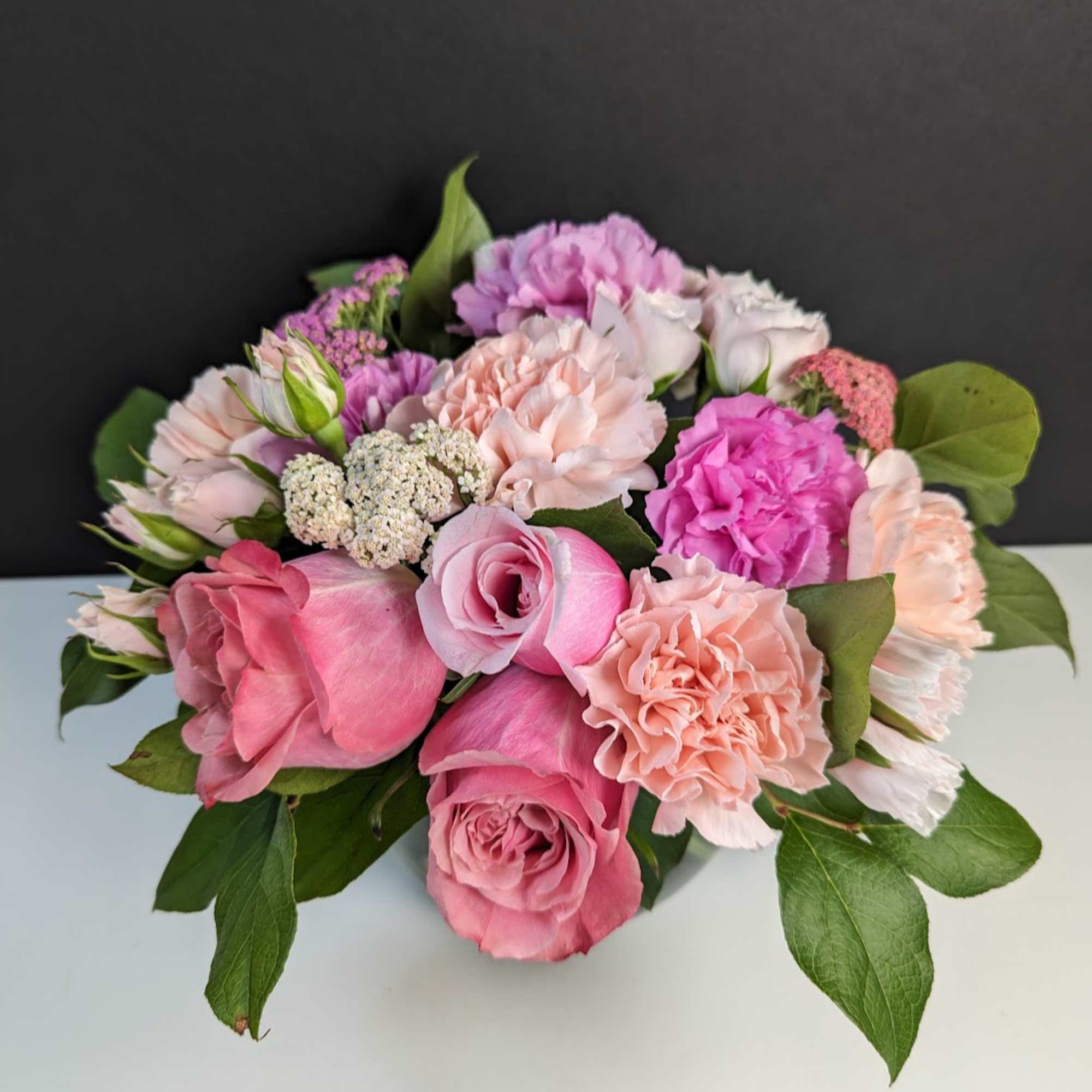 Pink and peach rose bouquet with carnations and small filler flowers
