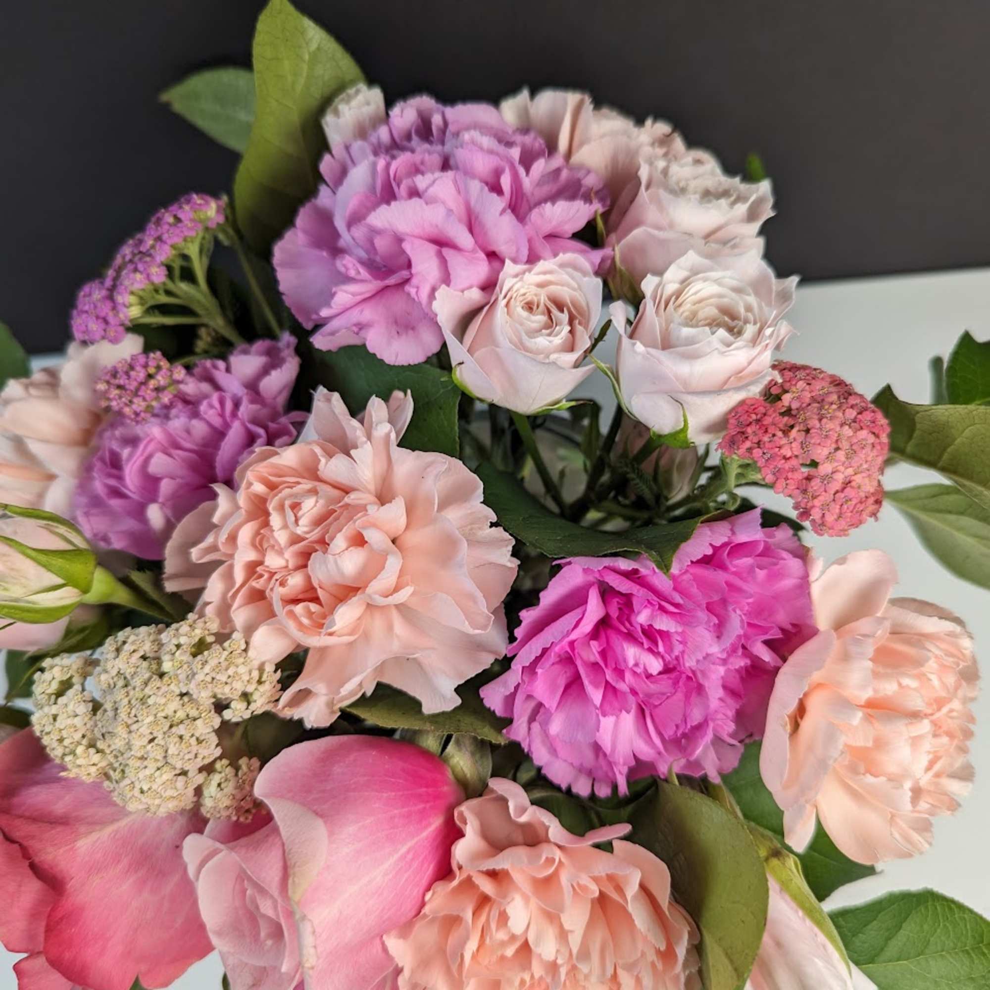 Bouquet of pink and peach flowers with roses and carnations