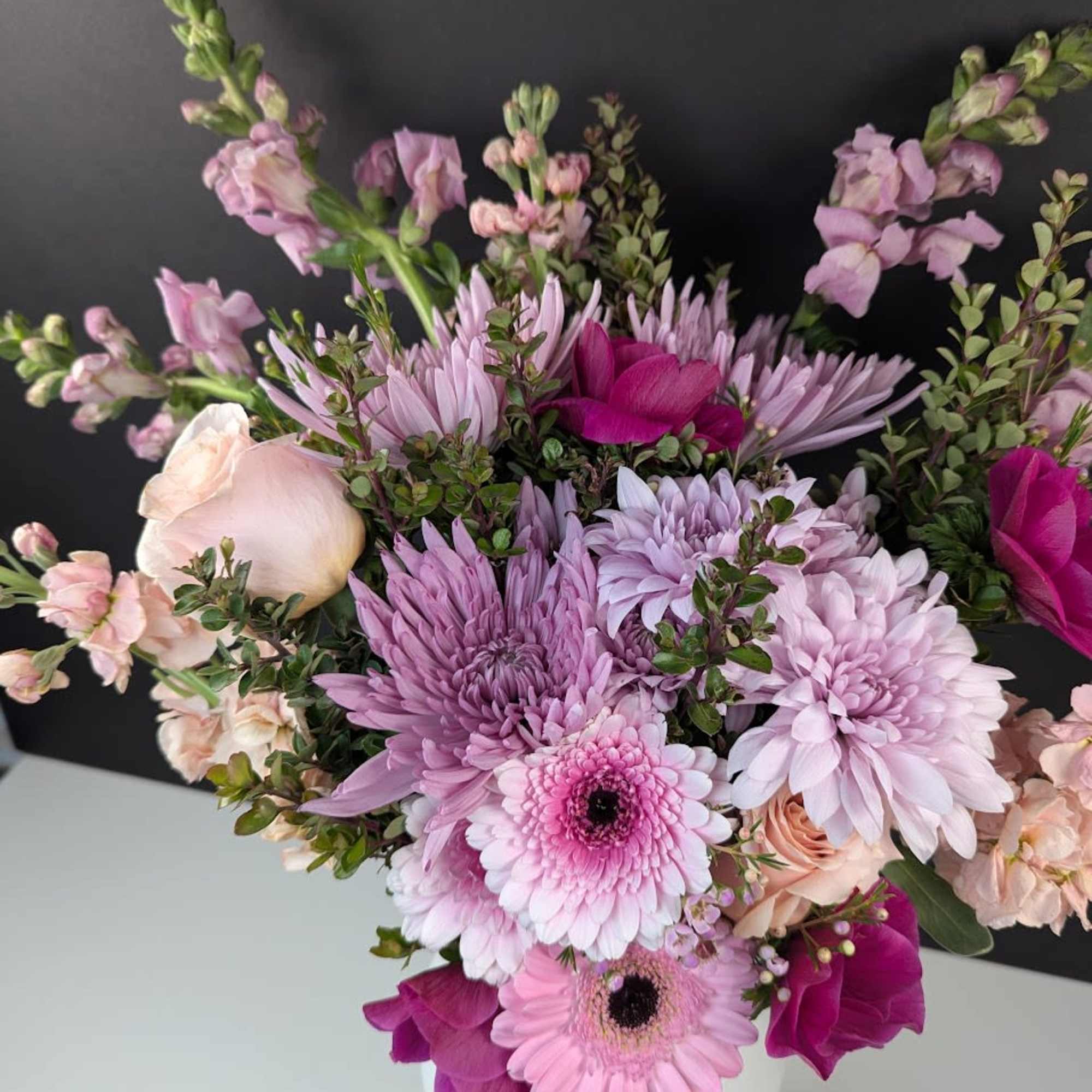 Pink and lavender mixed bouquet in a white vase