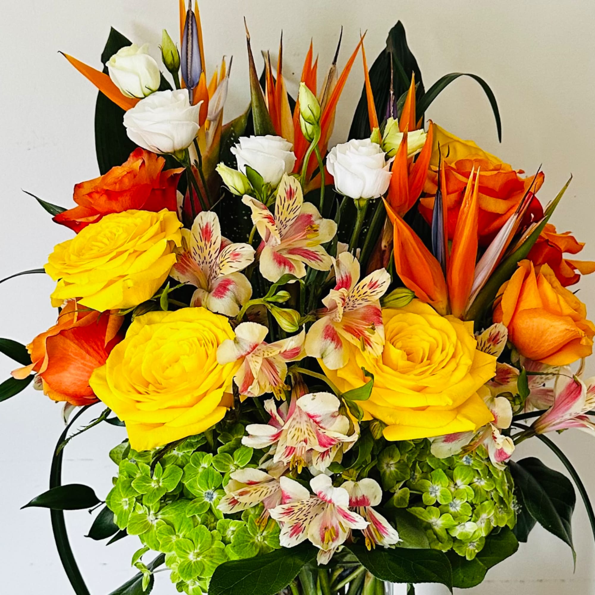 Bright mixed bouquet with yellow and orange roses and white blooms