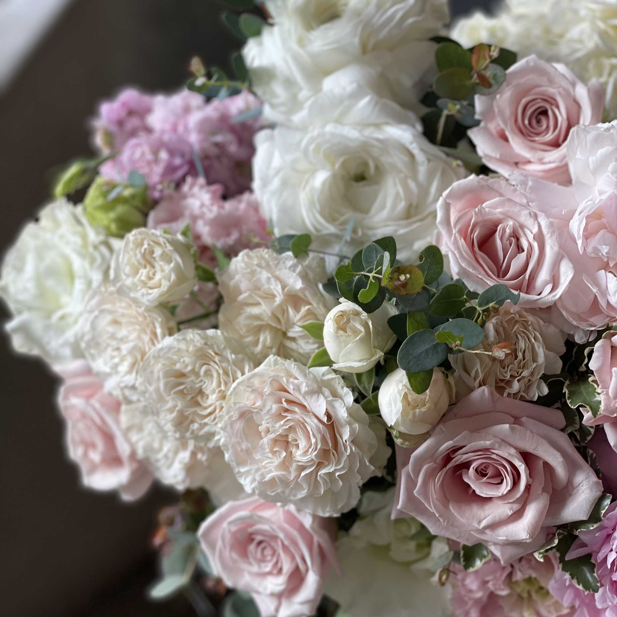 Bouquet of pale pink and white roses with eucalyptus