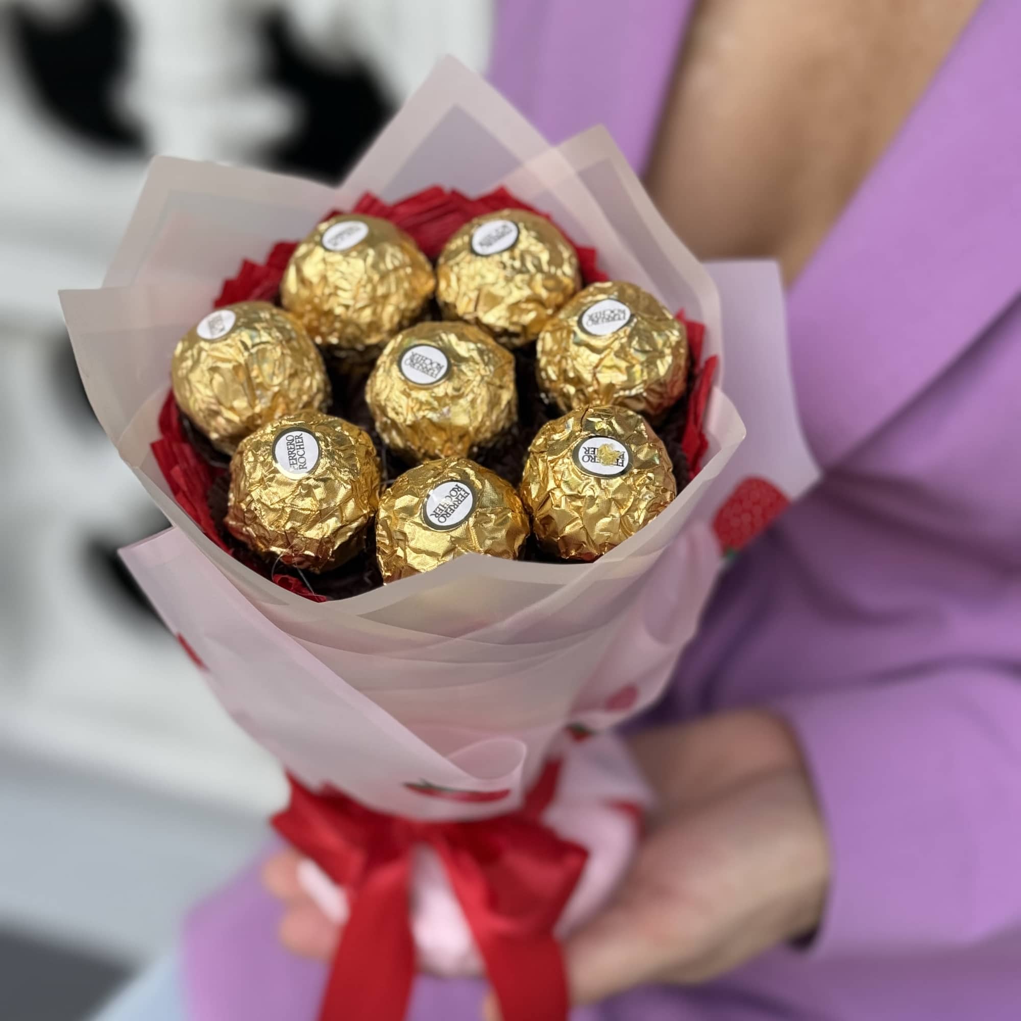 Glistening gold Ferrero Rocher chocolates artfully arranged like a hand-tied bouquet give